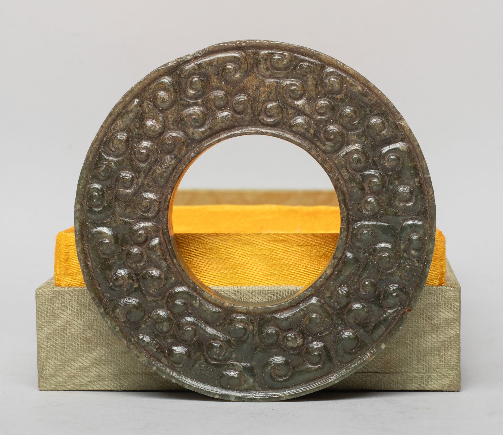 Estate Chinese Jade/ Stone Carved Pendant of Bi: The thick jade bi carved on both sides with archaistic beasts with raised scrolls, with box. Approx. 2.95 inch D (bi size). The Estate of the Store Closed Sale, DTLA, 2020.