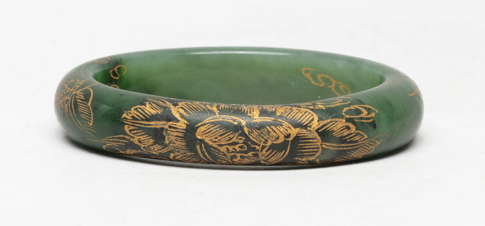 Estate Chinese Export Spinach Jade Bangle: Chinese spinach jade bangle, carved in low relief and gilded with peony and butterflies. Approx. 3 inch outer diameter, 2.3 inch inner diameter.