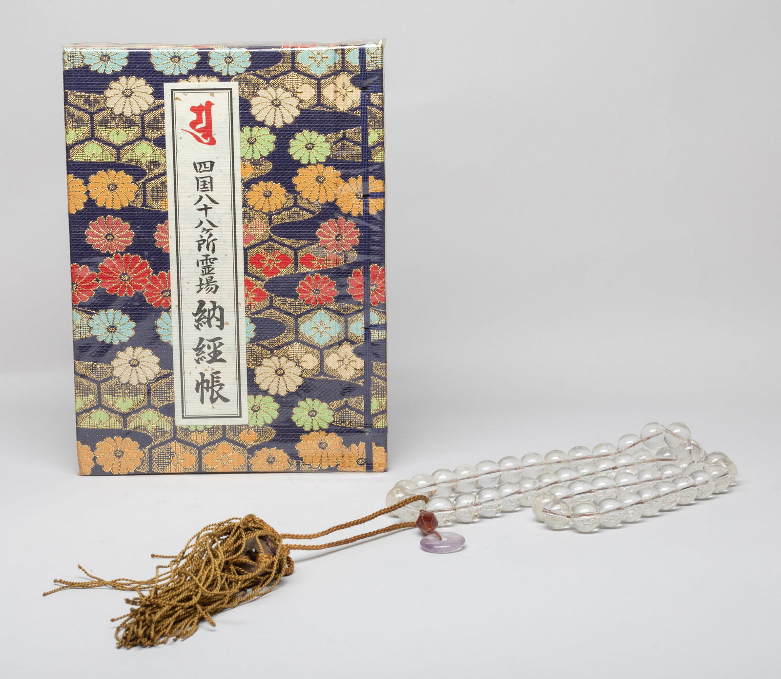 Chinese Export Rock Crystal Prayer Beads: Including a long string of Chinese rock crystal prayer beads, with an agate bead, an amethyst disc and tassel, and a book. Approx. 29 inch L (necklace size). The Estate of the DTLA. 2024.