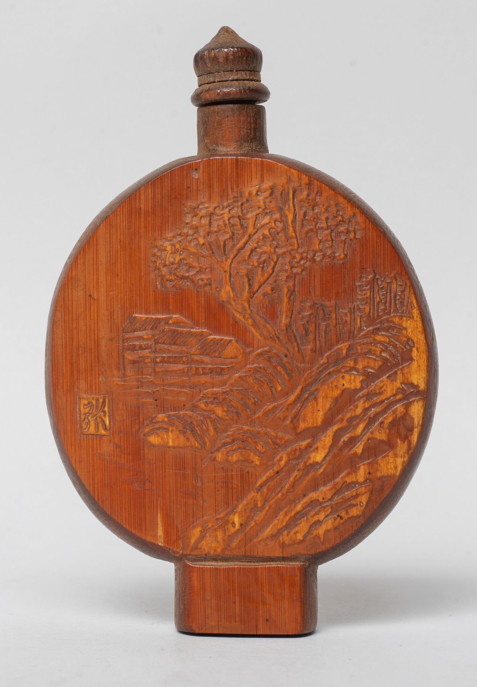 Estate Chinese Bamboo Carved Snuff Bottle: Of flattened rounded form, one side carved with landscape scene and inscribed with a character mark, with a stopper. Approx. 3.2*2.1*0.4 inch.