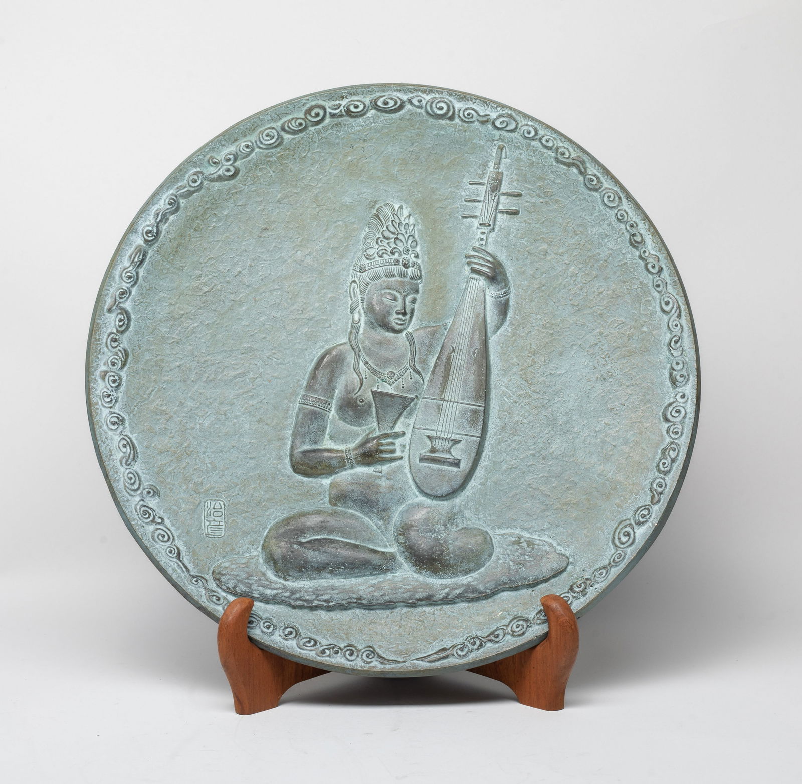 Japanese Taisho Heavy Bronze Plate: Japanese Taisho type heavy bronze decor plate, cast with a seated elegant lady playing with pipa, framed by a band of clouds, with a wood stand. Approx. 12 inch D.