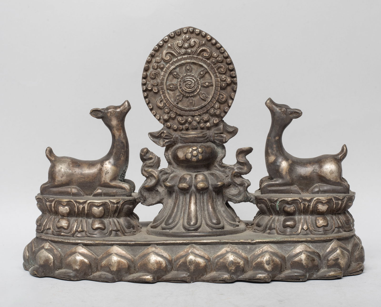 Chinese Bronze Temple Used Sculpture: Cast with two deer recumbent on waisted lotus thrones, surrounding a central attribute, all on a lotus base. Approx. 9*6.5*3.7 inch.