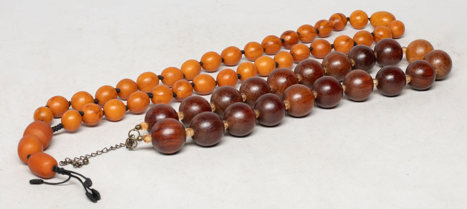 Estate Chinese Amber & Wood Prayer Beads: Two strings of Chinese amber and wood carved prayer beads. Approx. 0.9 inch D (larger bead size).