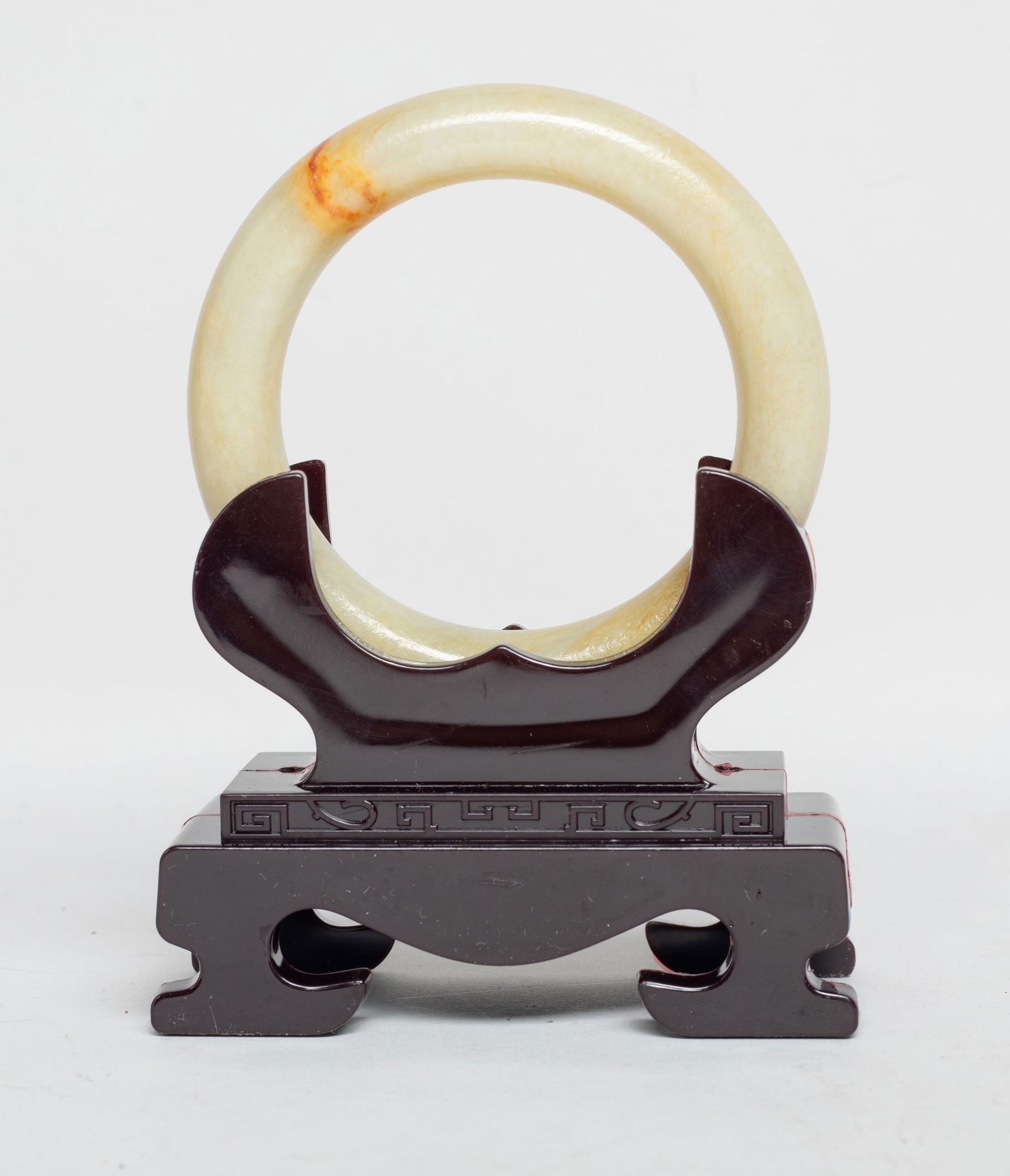 Vintage Chinese Russet Jade Bangle w/ Base: Collectible Chinese russet jade bangle, with a stand. Approx. 3.25 inch outer diameter, 2.3 inch inner diameter (w/o stand).