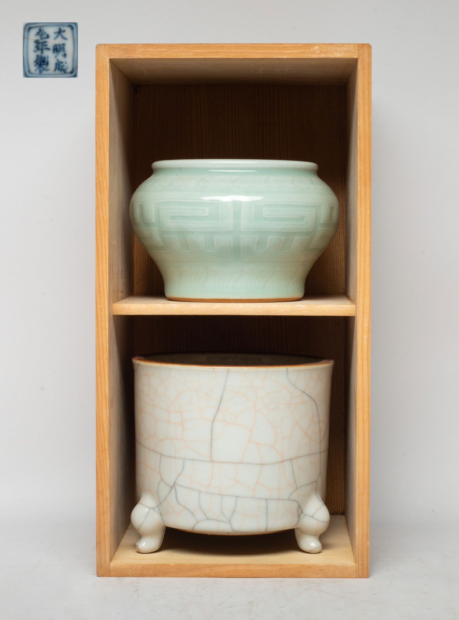 Estate Chinese Export Porcelain Censers: One censer overall covered with pale gray glaze, suffused with a matrix of brown and black crackles, the bottom with a seal mark, the other censer carved in low relief with traditional motif between b