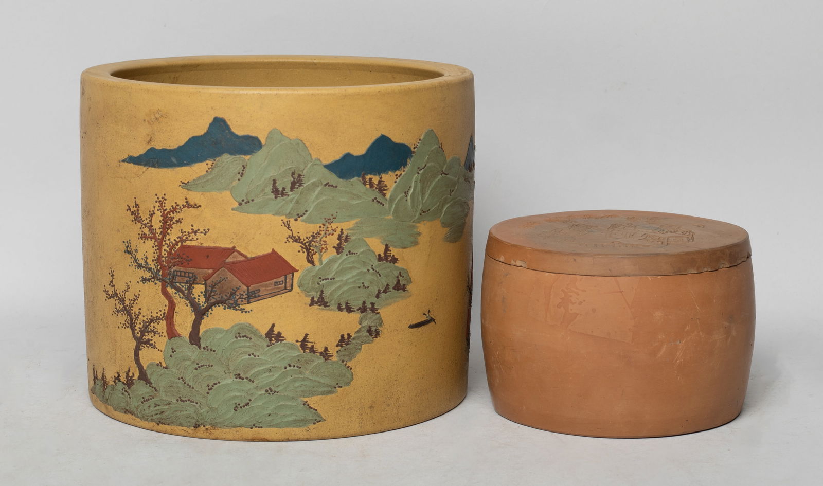 Chinese Zisha / Clay Brush Pot & Jar: The jar top carved with figural scene, the lid inside and the jar bottom with seal mark, the pot exterior decorated with continuous mountain landscape scene, the bottom with a seal mark. Approx. 6.8*5