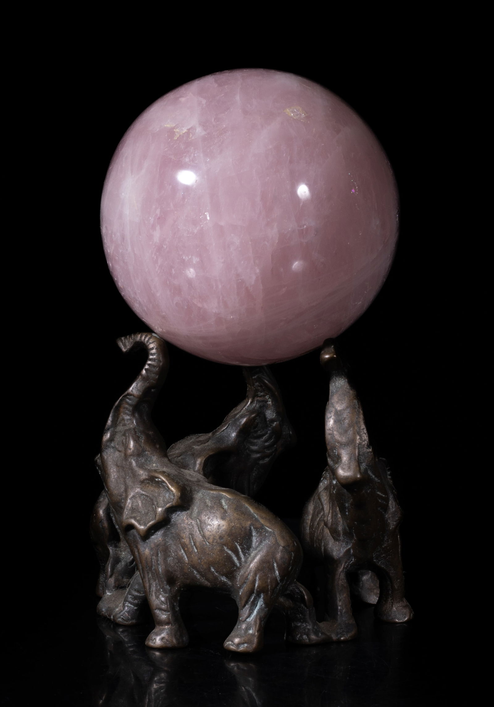 Vintage Rose Quartz Large Ball on Stand: Vintage collectible rose quartz carved ball, the surface finely smoothed, with a stand cast as three elephants with noses lifting upward. Approx. 4 inch D (ball size).