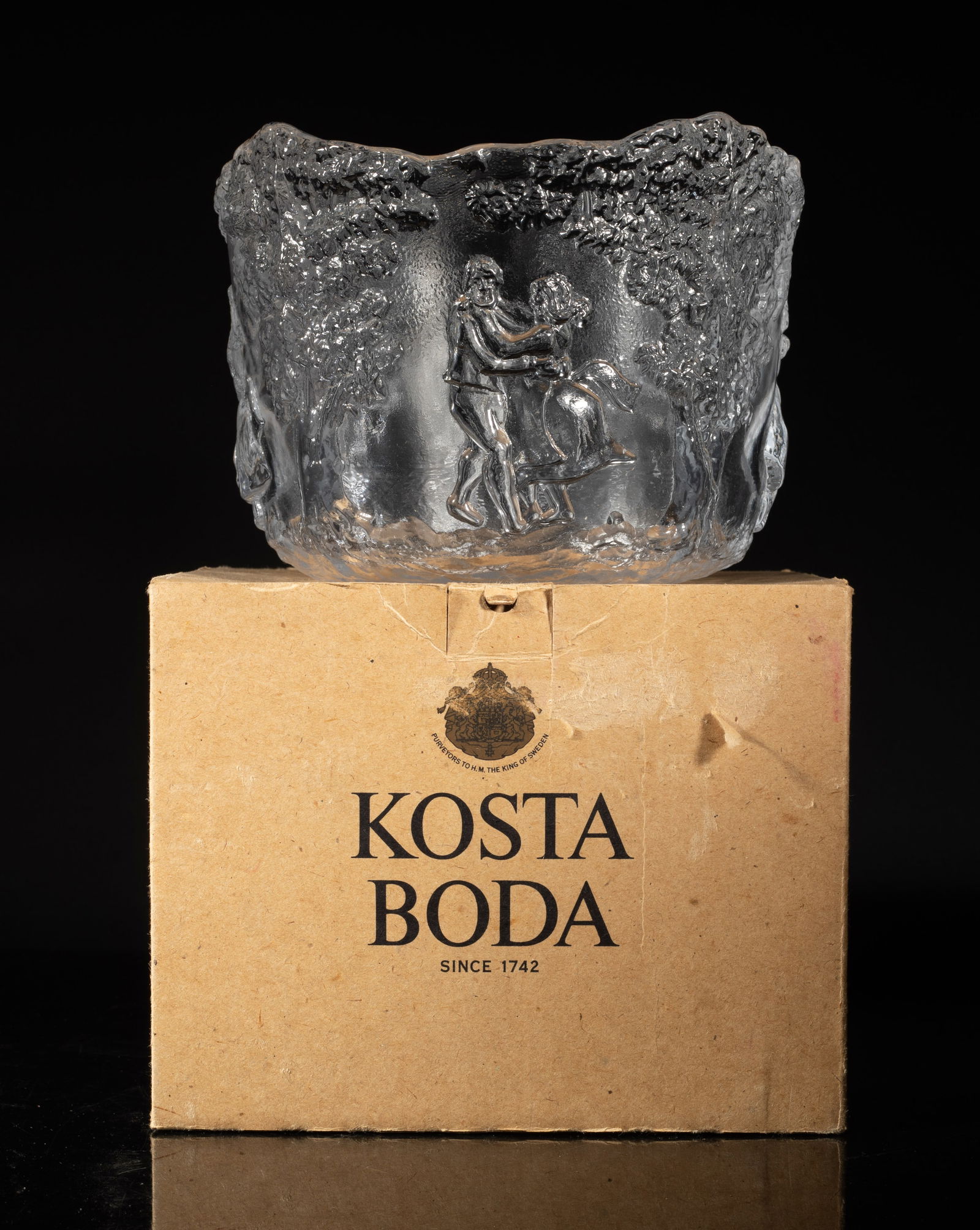 Vintage Kosta Boda Crystal Glass Bowl: Vintage Kosta Boda crystal glass large bowl, the exterior carved in high relief with dancing men and women under trees, with box. Approx. 7.4*5.5 inch (bowl size).