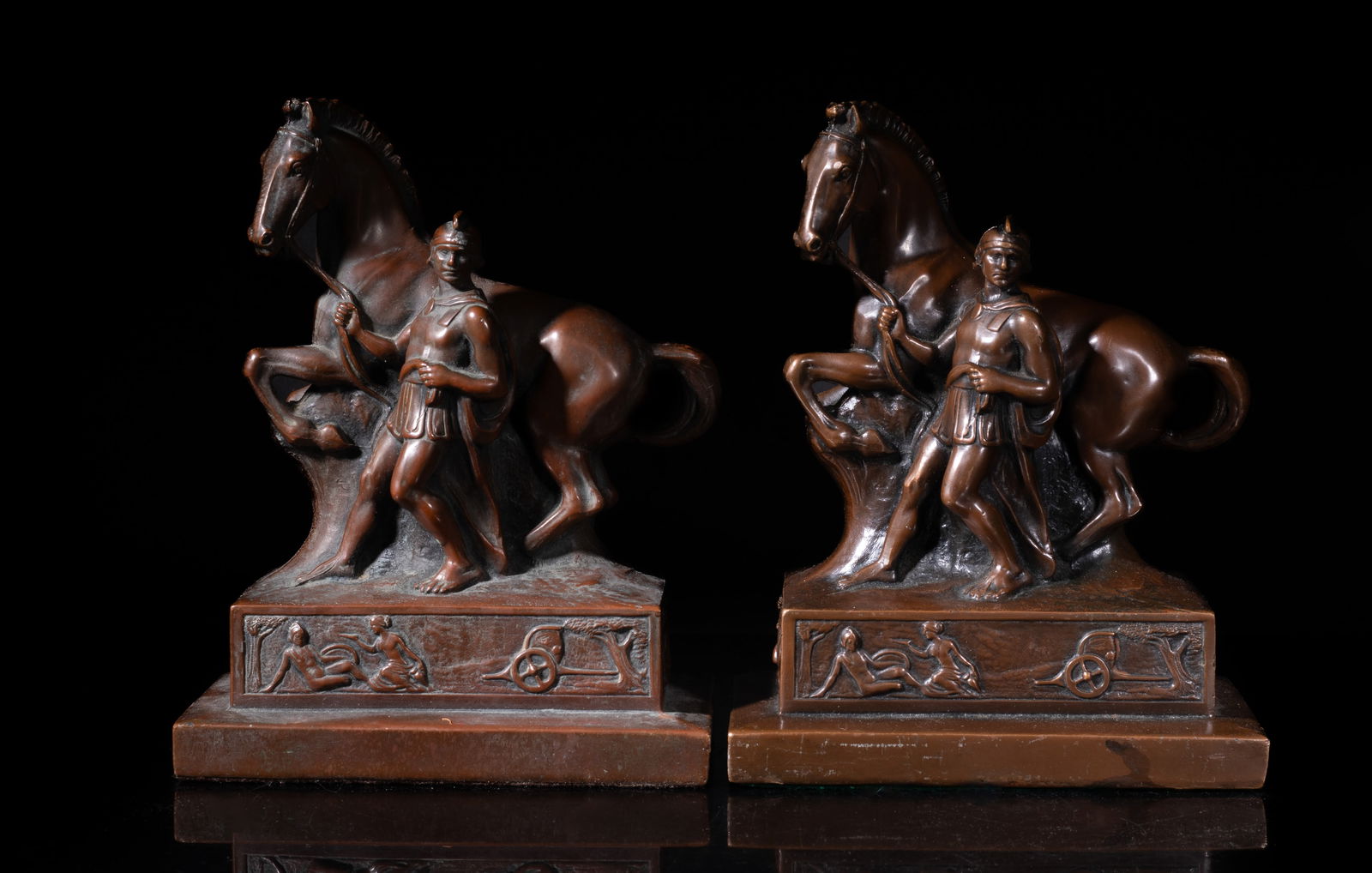 Two Early 20th Bronze Sculptures Bookends: Each cast as a soldier pulling the veins of a horse, the base decorated with figural training scene, the base marked JB 1528. Approx. 6.8*5.4*3.1 inch (each).