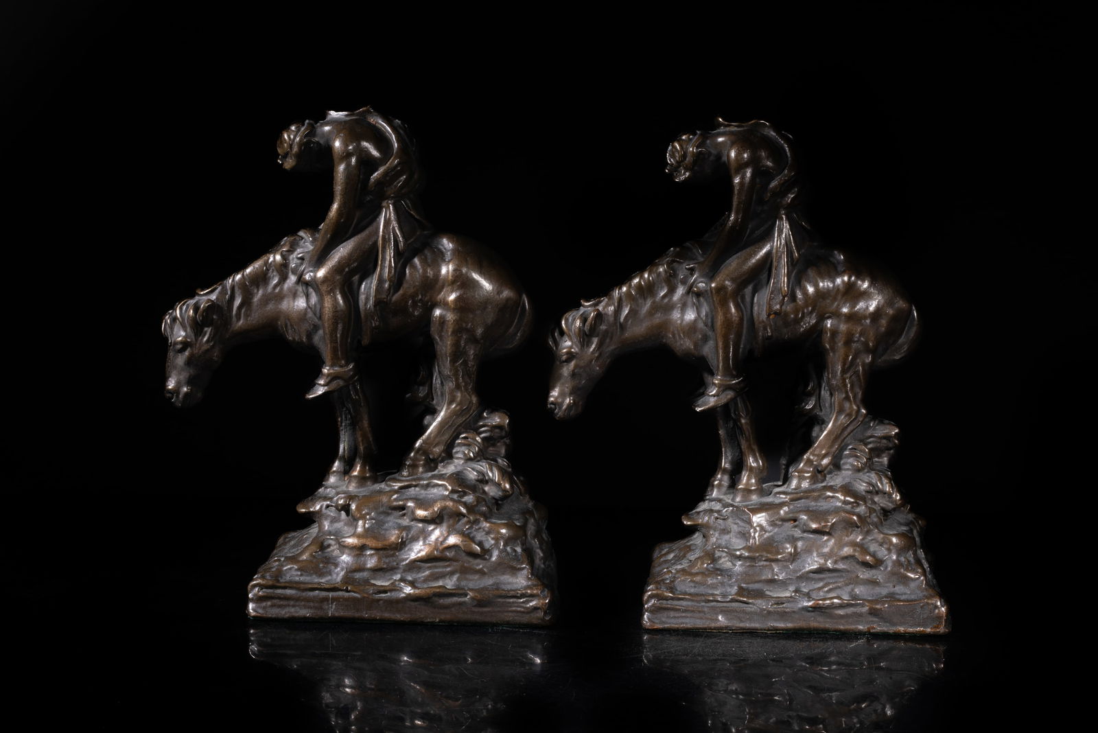 Two Early 20th Bronze Sculptures Bookends: Each cast as a tired man holding a spear and riding on a horse, the bottom with a sticker marked GALVAND BRONZE P. MORI & SON. Approx. 8*6*2.7 inch (each).