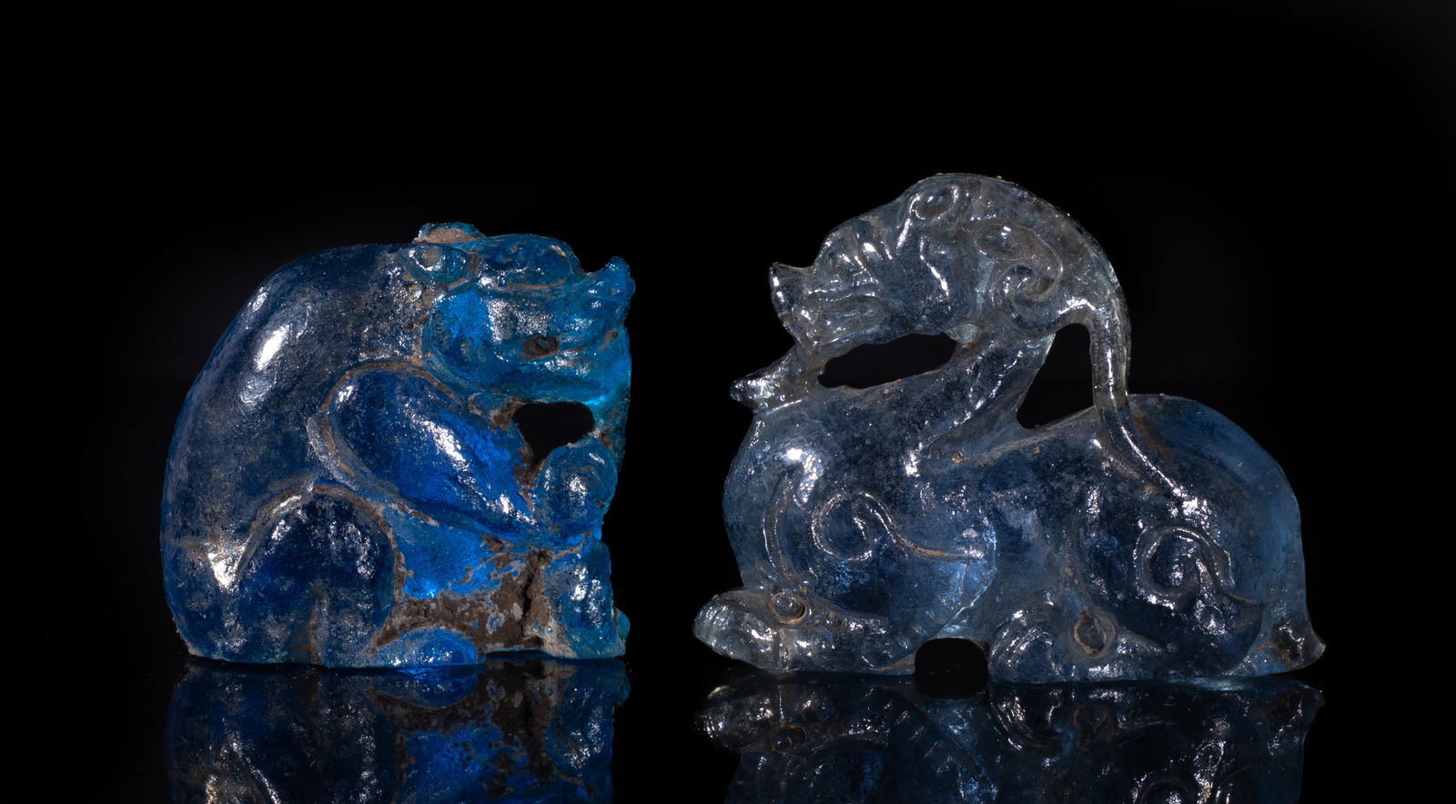 Two Rare Chinese Glass Beast Pendants: Two collectible Chinese translucent blue glass pendants carved of beast form. Approx. 2*1.6*0.6 inch (larger).