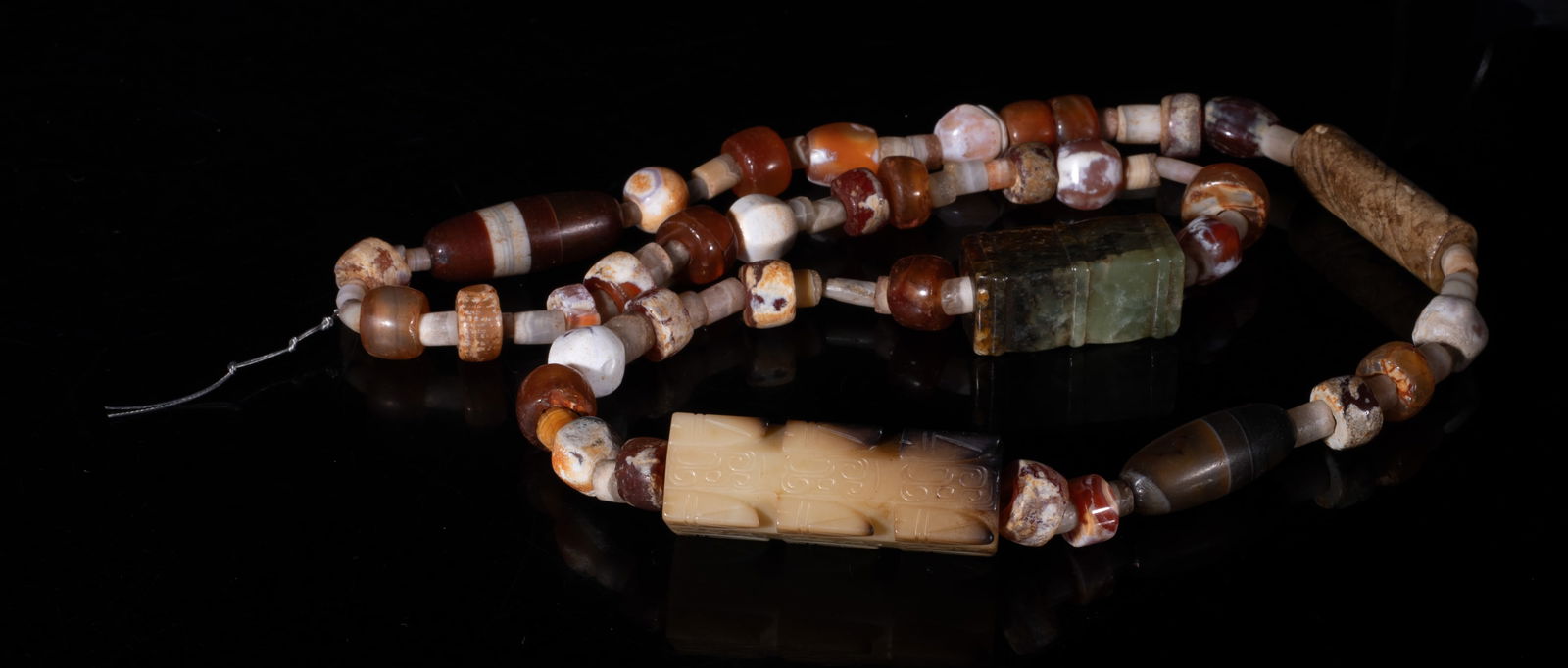 Rare Chinese Cameo Agate, Jade Necklace: Chinese cameo agate bead necklace, with three russet jade toggles, the largest toggle carved with archaic patterns. Approx. 27 inch L.