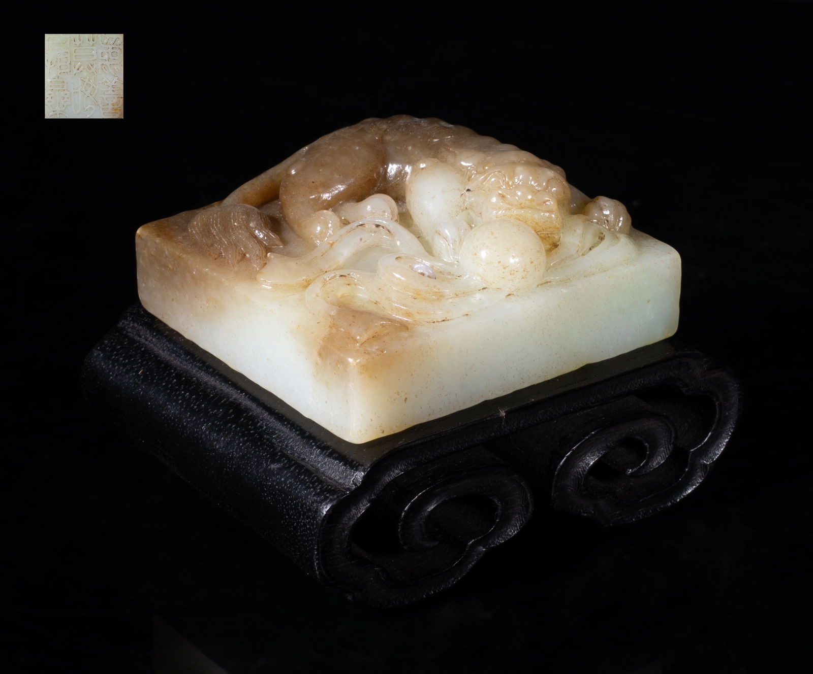 Chinese Russet Jade Seal w/ Base: Large Chinese russet jade seal of almost square shape, the top carved in high relief with a recumbent beast chasing a beribboned ball, detailed with finely incised mane and tail, with stand. Approx.