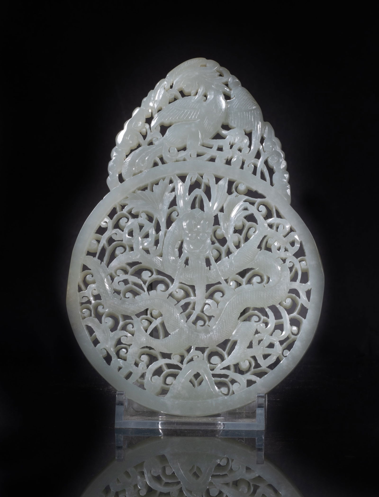 Estate Large Chinese Jade Plaque: Of circular shape, finely carved in openwork with a scaly dragon undulating among foliate scrolls, surmounted by a phoenix among lingzhi stems on the top. Approx. 4.9*3.5 inch.