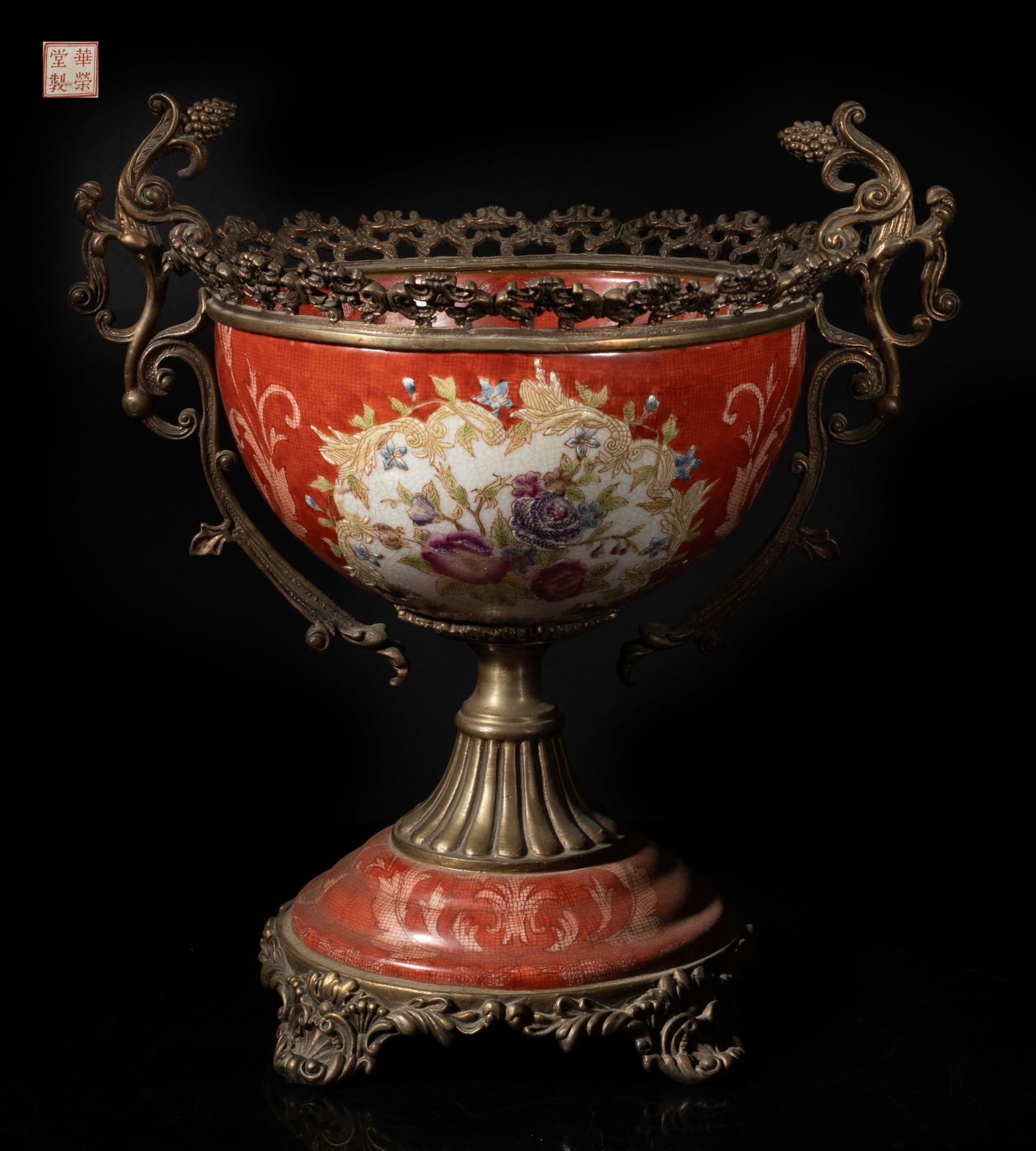 Vintage Chinese Porcelain Central Bowl: The bowl exterior decorated with two medallions of flowers, against crackled red background decorated with foliage, set with metal cast foliage form handles, rim and base, the bottom with a seal mark.