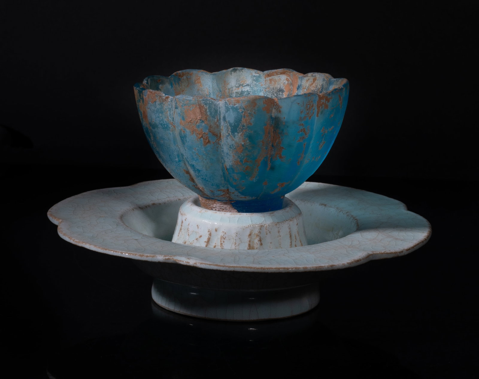 Rare Chinese Porcelain Base w/ Glass Bowl: The porcelain base of floral form, applied in pale sea-green glaze suffused with a matrix of crackles, with a blue glass bowl of floral form. Approx. 5.7*1.5 inch (stand size).