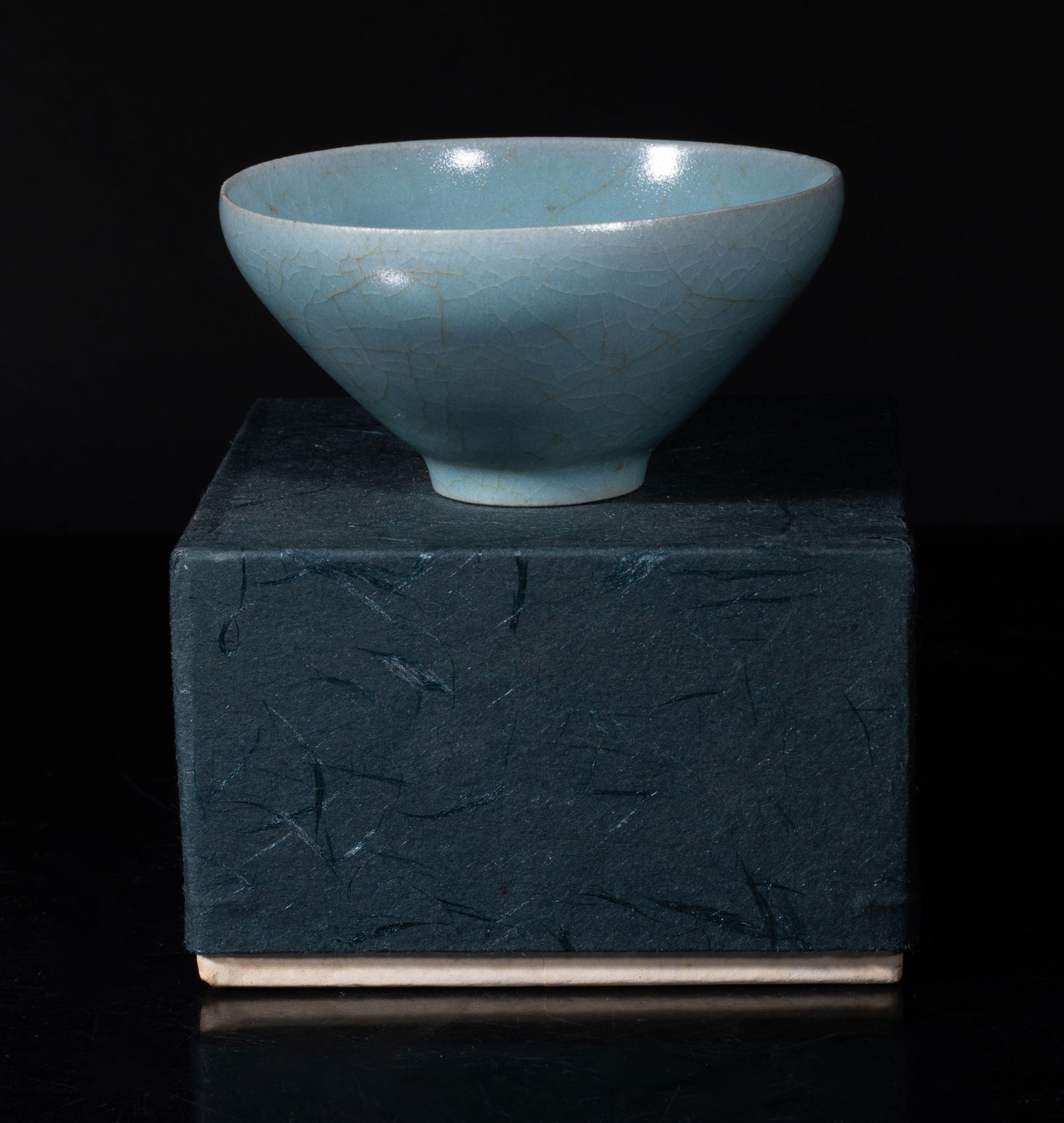 Estate Chinese Celadon Glazed Porcelain Tea Cup: Of conical form rising from a short foot to a gently incurved rim, overall covered with soft blue glaze suffused with a matrix of crackles, with box. Approx. 3.3*1.6 inch (w/o box).