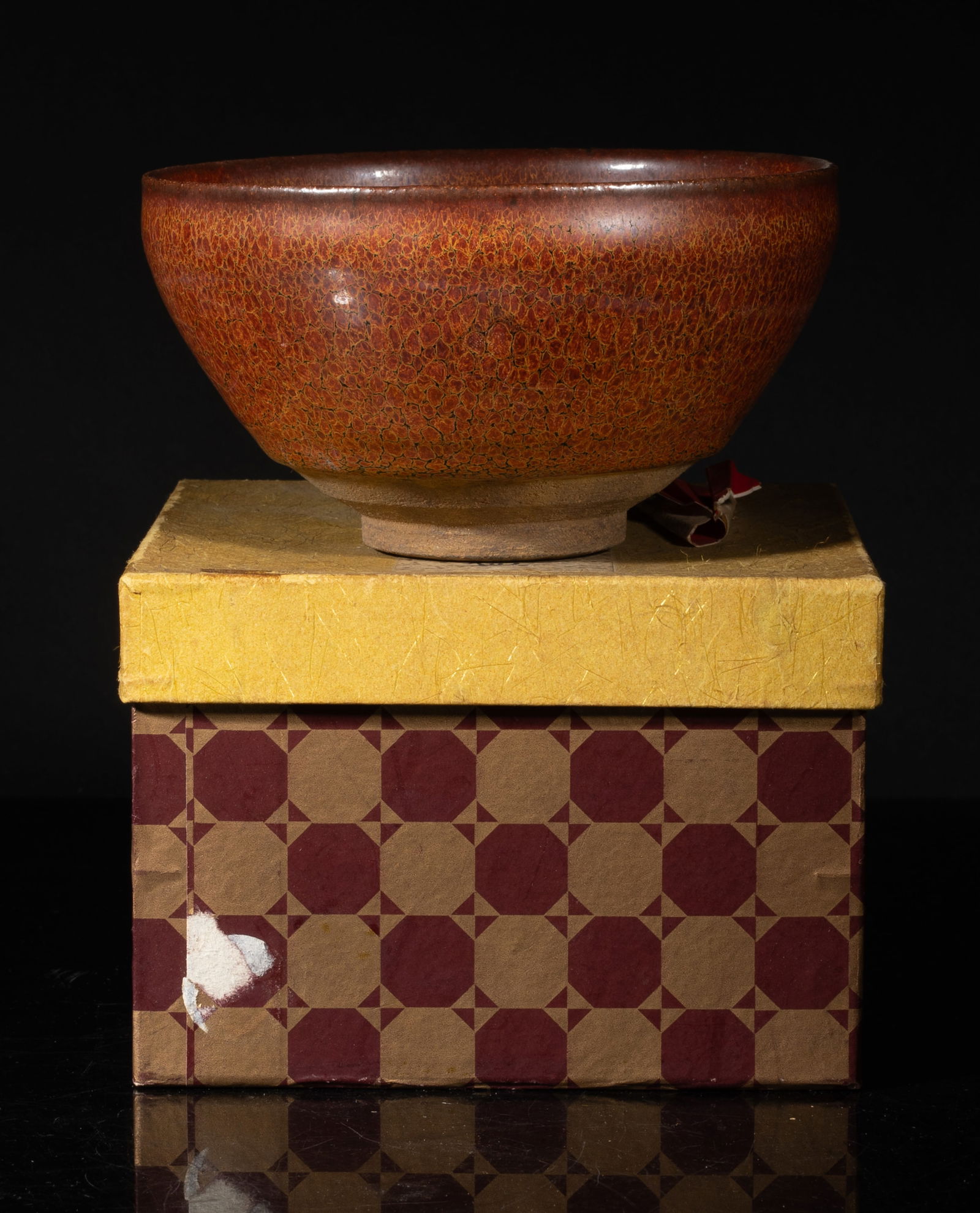 Chinese Export Flambe Glazed Porcelain Tea Bowl: Well potted with deep, curving sides rising to a slightly inverted rim, covered overall in a dark brown glaze suffused with red brown splashes in imitation of tortoiseshell, the glaze stopping above