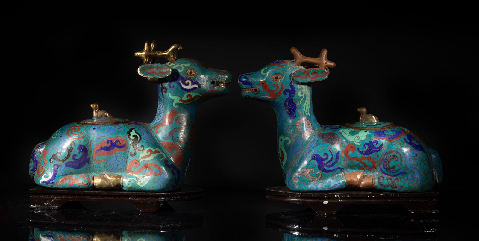 Pair Chinese Large Cloisonne Sculptures: A pair of Chinese cloisonne sculptures of recumbent deer form, enameled with archaistic beasts amongst clouds on turquoise glazed body, the back pierced with an aperture and set with a stopper, with s