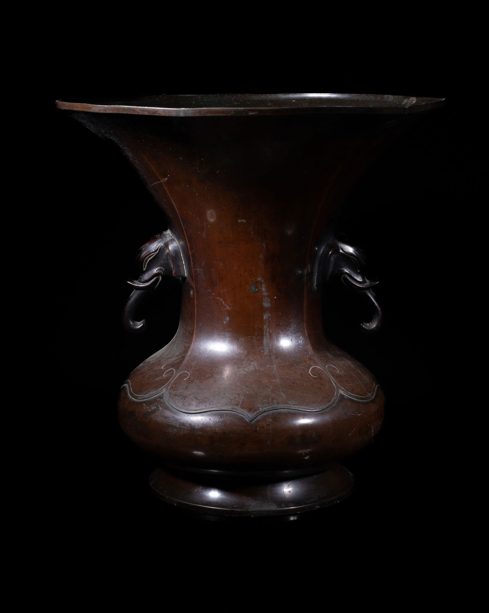 Antique Japanese 18/19th Bronze Vase: Of compressed form rising from a splayed foot to a large flared mouth, flanked by a pair of elephant head handles. Approx. 12.5*12 inch.