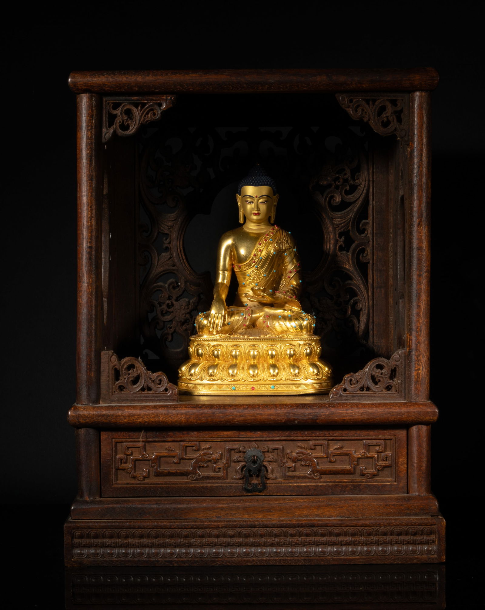Chinese Gilt Bronze Buddha w/ Cabinet: The Buddha cast seated on a waisted lotus base, the left hand holding a bowl and right hand resting on knee, with a wood cabinet. Approx. 12*8.25*16.25 inch (cabinet size).