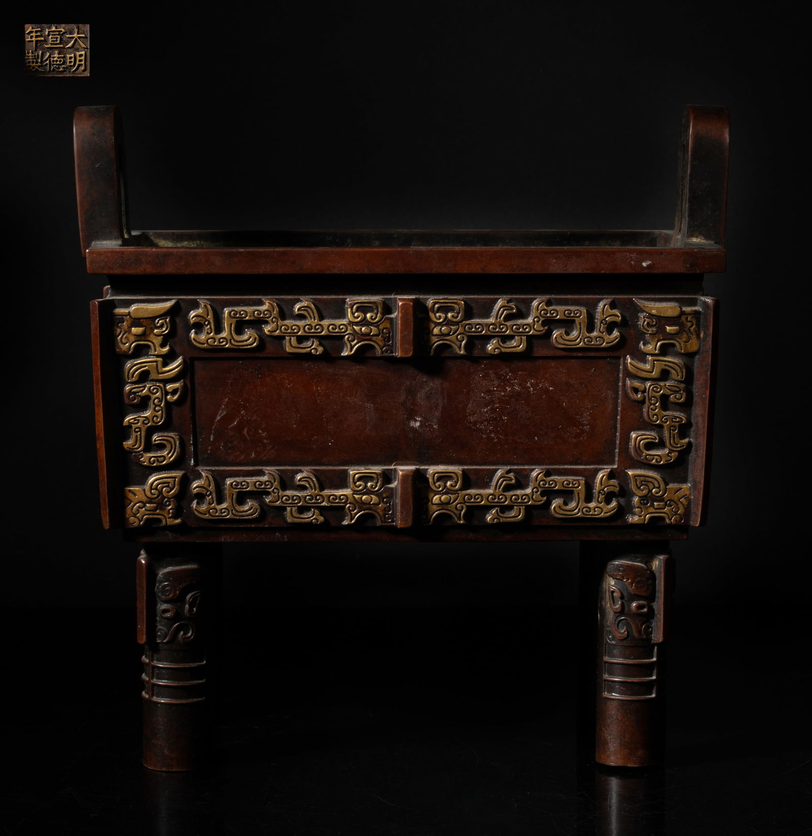 Large Chinese Bronze Ding Form Censer: Of rectangular section with two handles and four legs, each side cast with a band of archaistic beasts divided by raised flanges, each leg cast with beast mask, the bottom inscribed with a six-charact