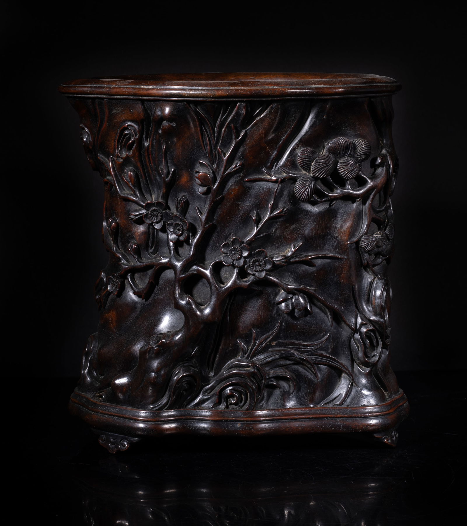 Chinese Hardwood Carved Brush Pot: Worked of gnarled branch form, the exterior carved in high relief with pine tree, plum blossoms and bamboo. Approx. 8.4*7.7*5.7 inch.