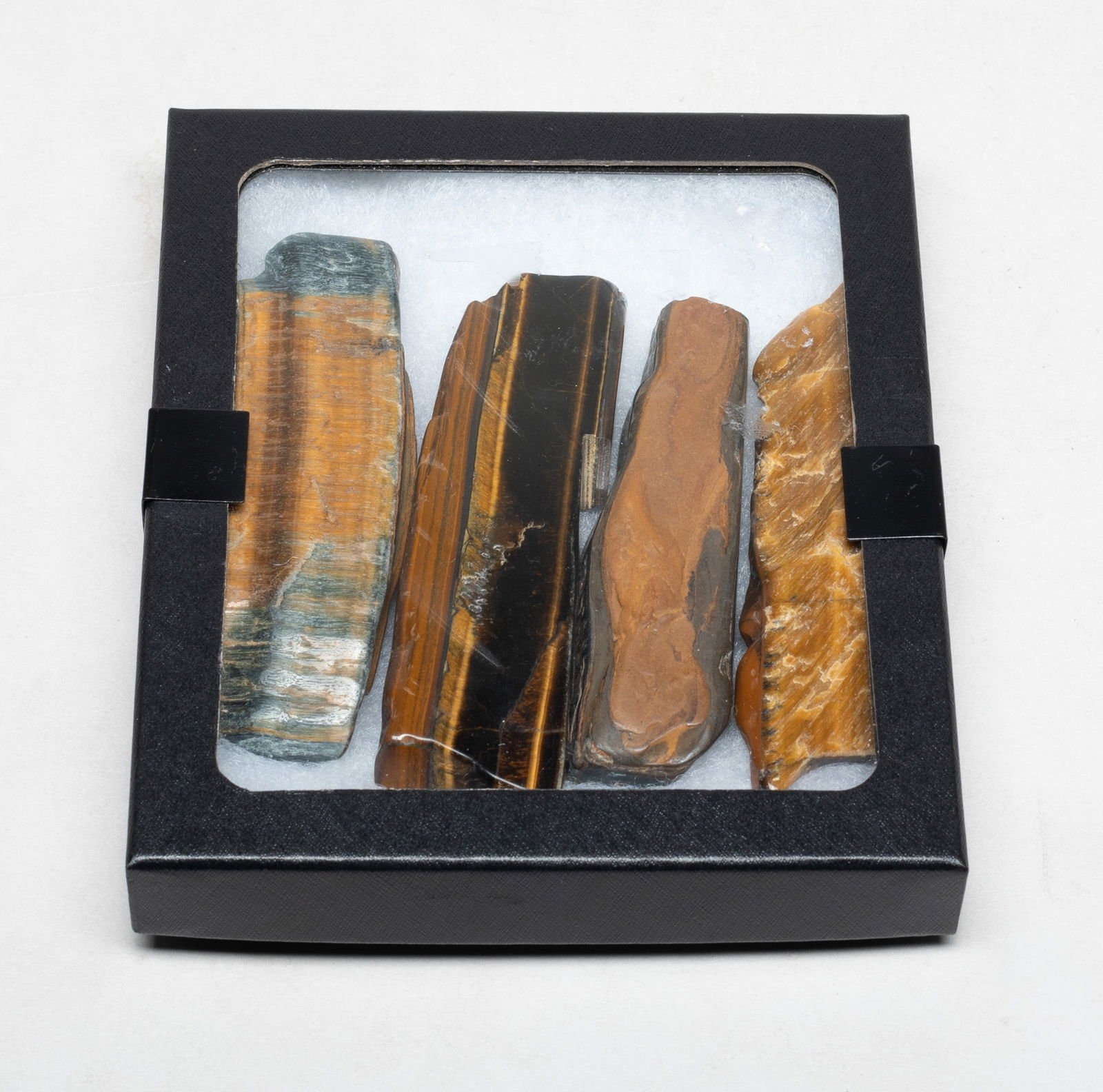 Set Collectible Tiger-eye Gemstone Sticks: Set of four tiger eye gemstone sculptures, with box. Approx. 4.5*1.2*0.5 inch (largest).