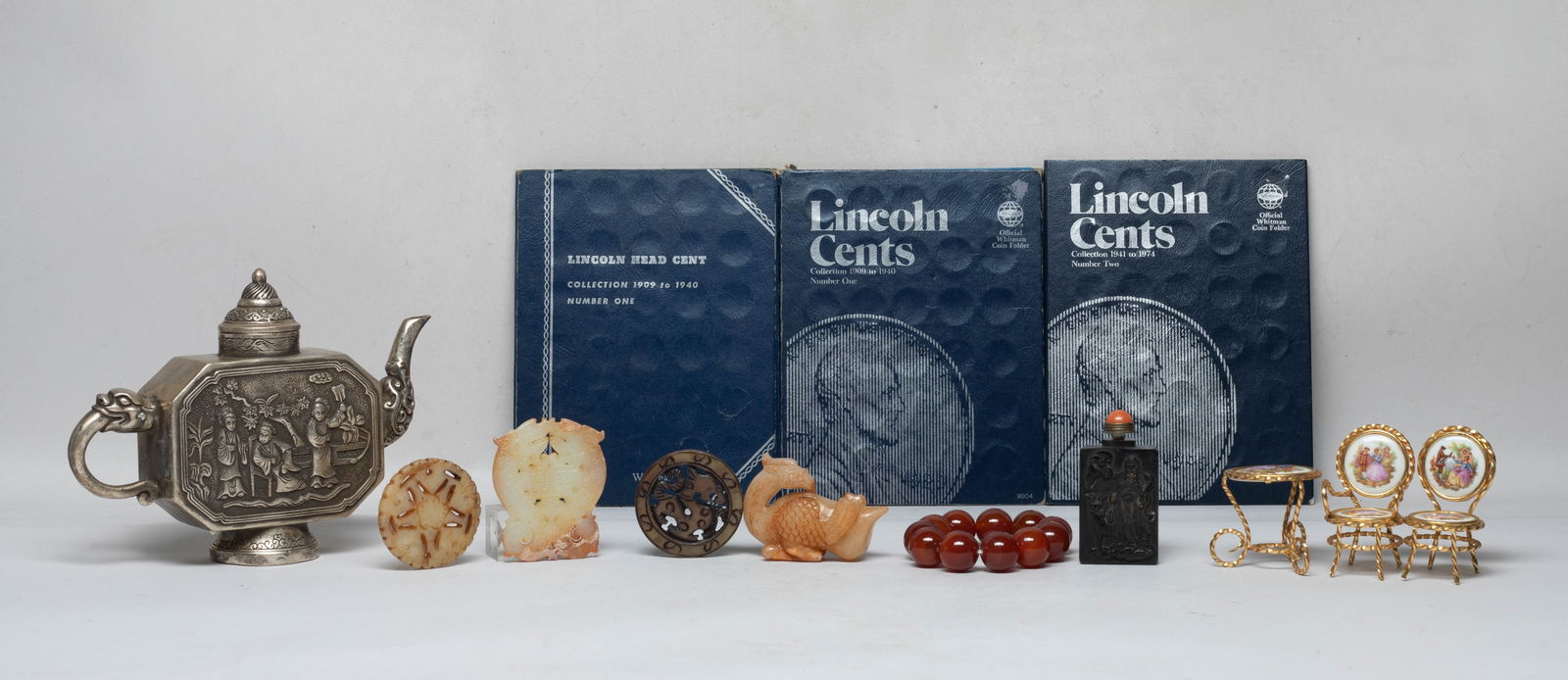Estate US Coins, Chinese Stones, Metal Pot: Including American one cent coins, Chinese stone carvings, a bead bracelet, a snuff bottle carved on one side with figure, bat and deer, the reverse with horse, a metal pot cast with figural scene,