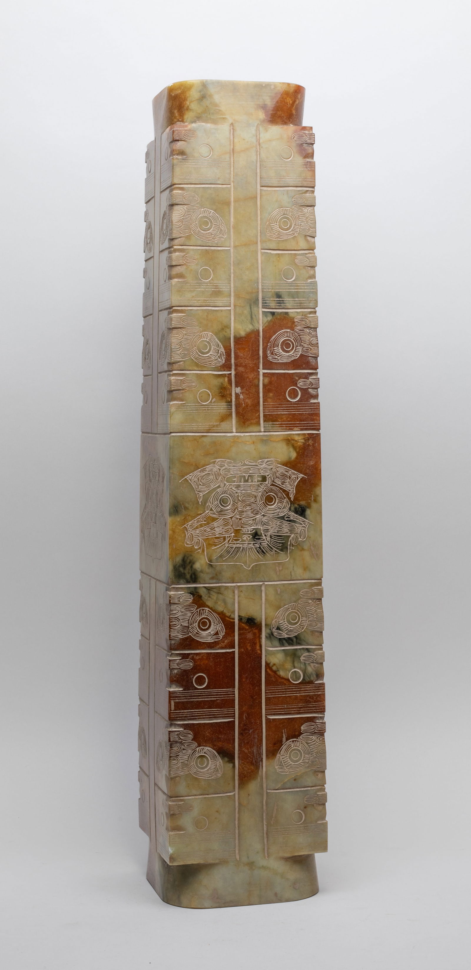 Massive Chinese Jade/ Hard Stone Cong: The cylindrical tube combined with a square- section body cut with groups of horizontal bands forming stylized masks along the edges. Approx. 23.1*4.6*4.5 inch.