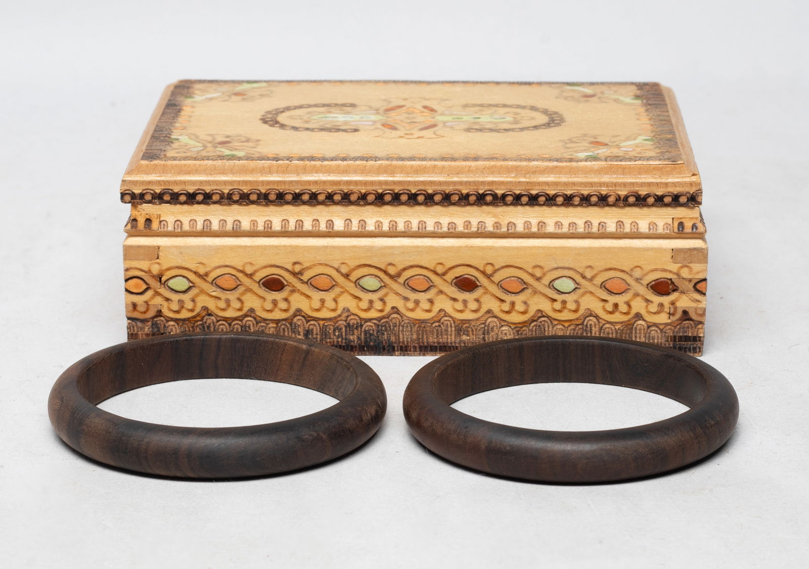 Two Collectible South Asian Agarwood Bangles: Two collectible South Asian agarwood carved bangles, with box. Approx. 35 gram (total weight), 3.07 inch outer diameter, 2.5 inch inner diameter (bangle size).
