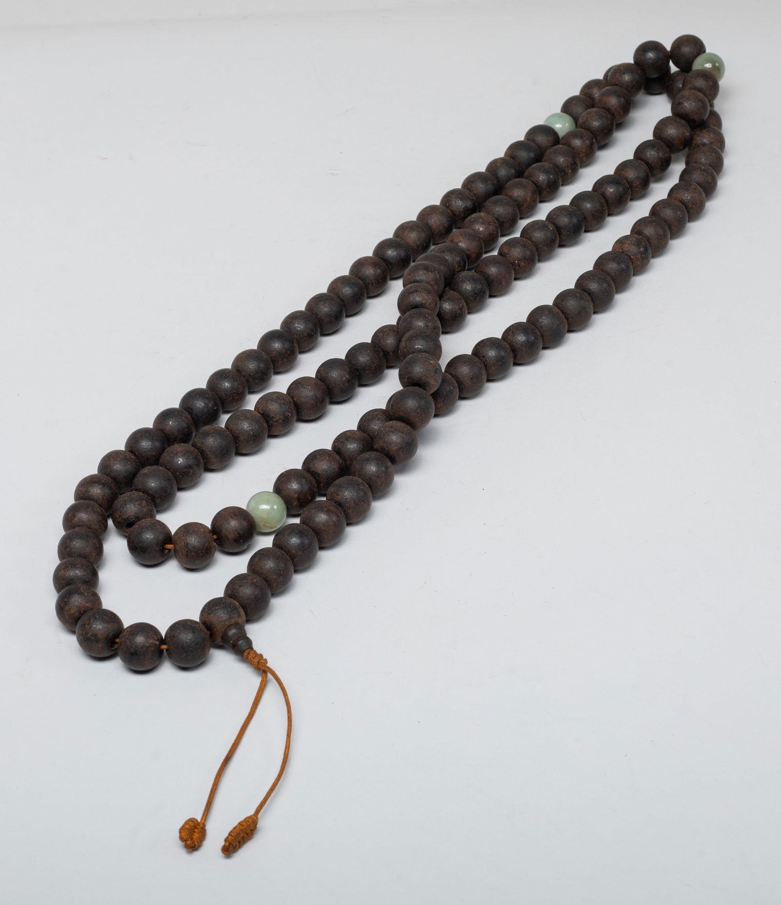Estate Chinese Long Agarwood Prayer Beads: A long string of Chinese agarwood carved prayer beads, with three stone beads, slightly fragrant. Approx. 62 inch L, 264 gram (total bead weight).