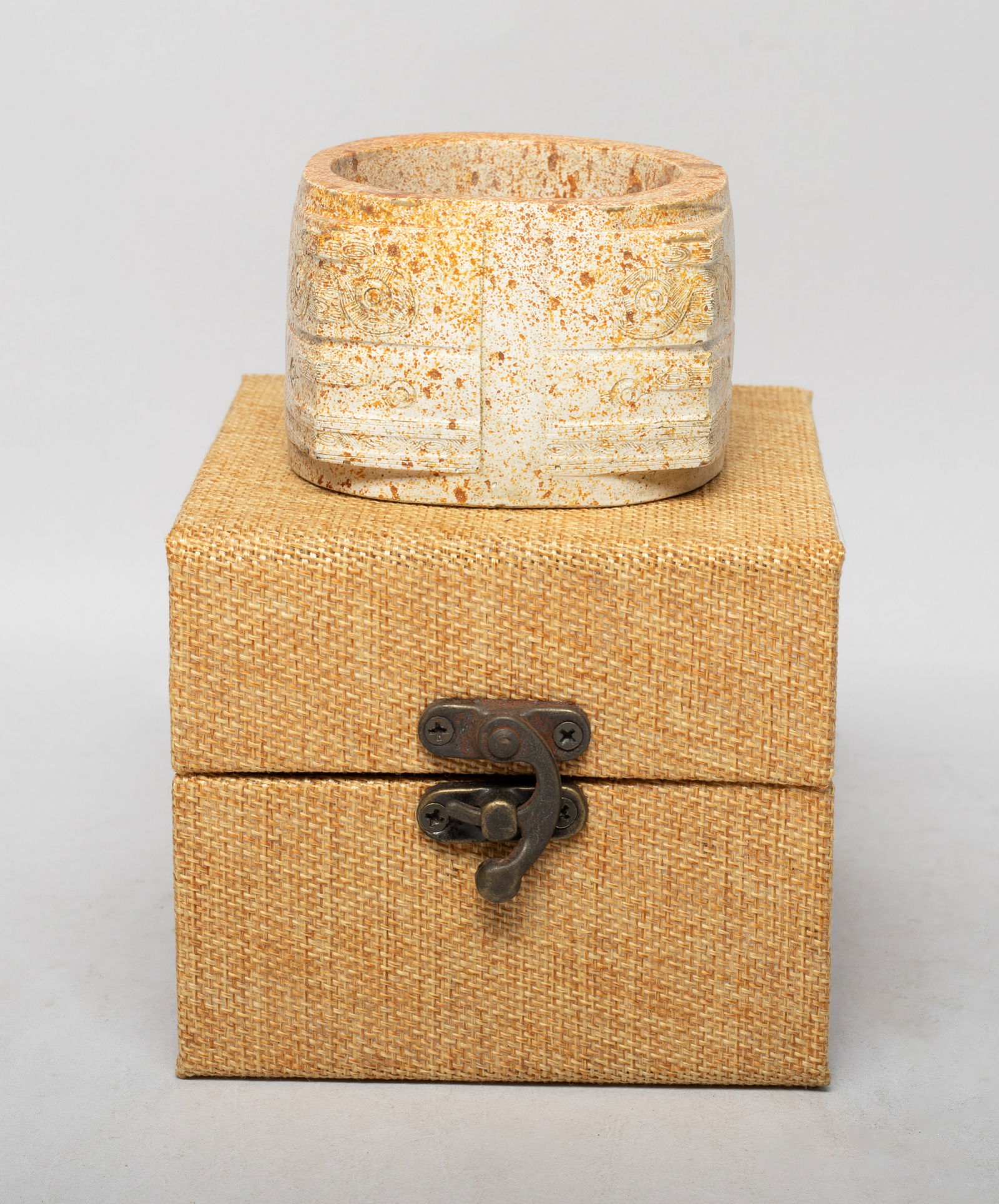 Chinese Burnt Jade/ Stone Sculpture: Short and stout with a thick cylindrical body supporting square corners along four sides, each corner carved in two registers with stylized animal masks, with box. Approx. 2.95*2.95*2 inch (w/o box).