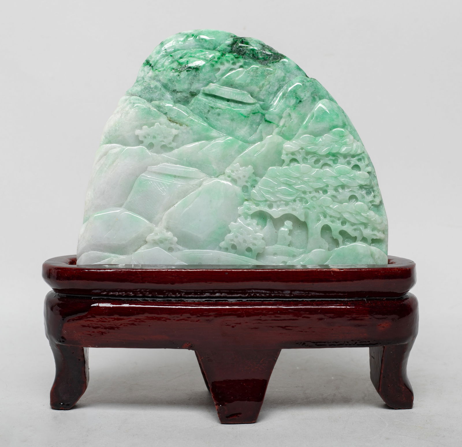 Vintage Chinese Jade Jadeite Table Sculpture: Carved in varying levels of relief as a craggy mountainscape encompassing scattered pine trees and two pavilions, with stand. Approx. 4.8*4.15*0.5 inch (w/o stand).