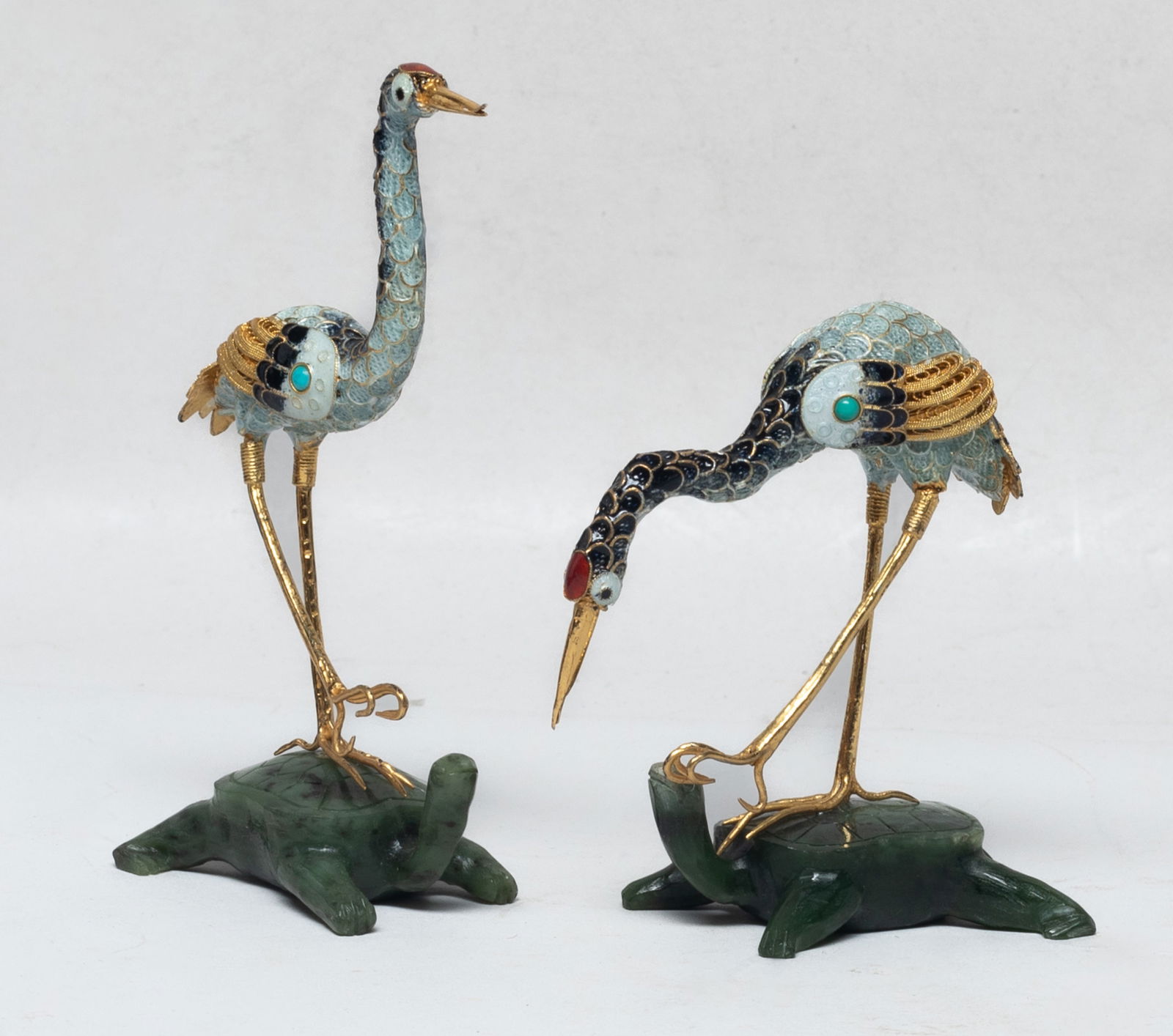 Chinese Gold on Sterling Silver on Jade Crane: Two Chinese gold on sterling silver sculptures of crane form, the body applied with black, white and red glaze, supported on a jade carved turtle form base. Approx. 4.4*2.2*1.6 inch (larger).