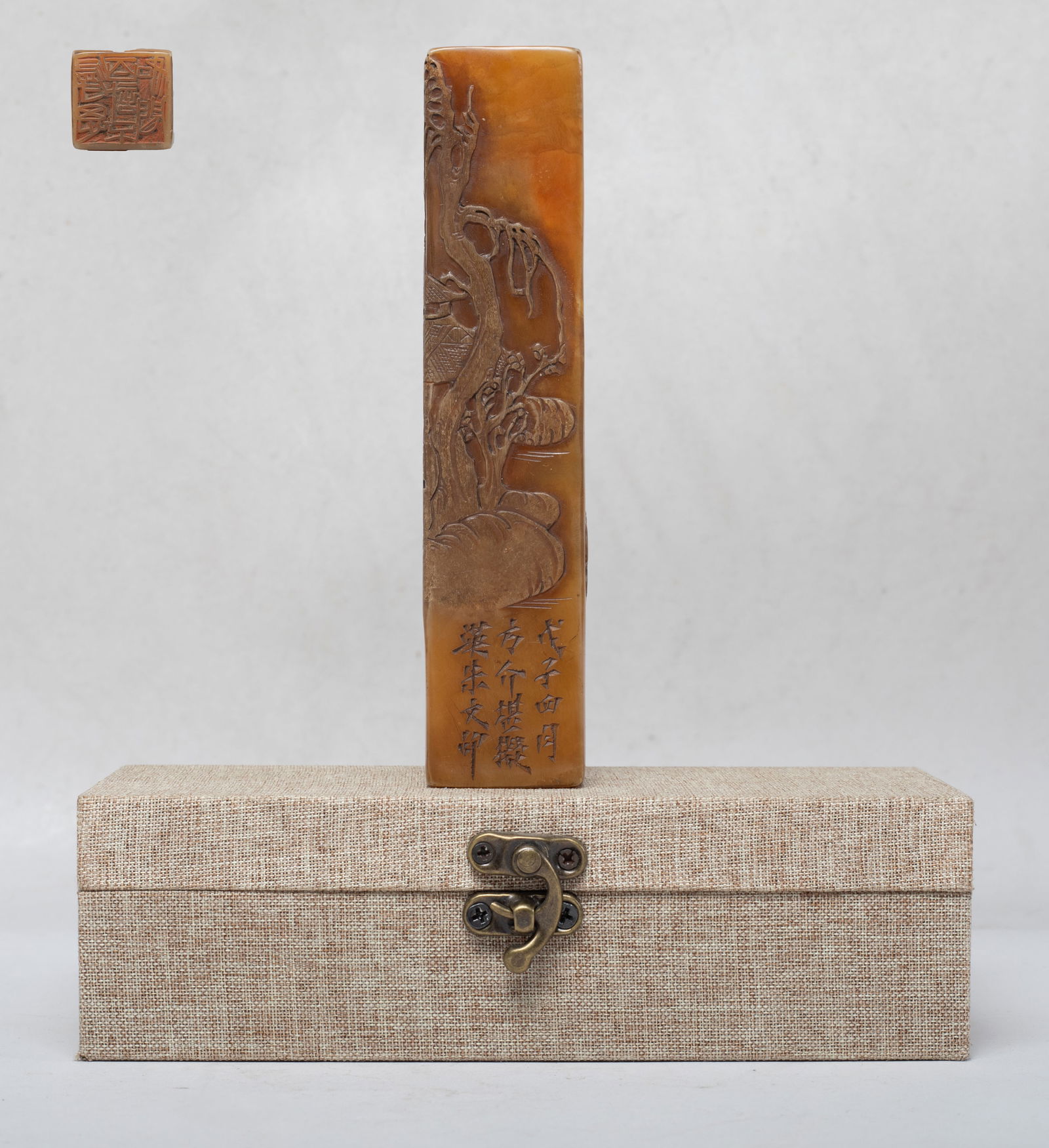 Collectible Chinese Export Russet Stone Seal: Of tall square section, the sides carved with two scholars standing in a pavilion under a a gnarled tree, incised with inscription, with box. Approx. 5.75*1.25*1.25 inch (w/o box).