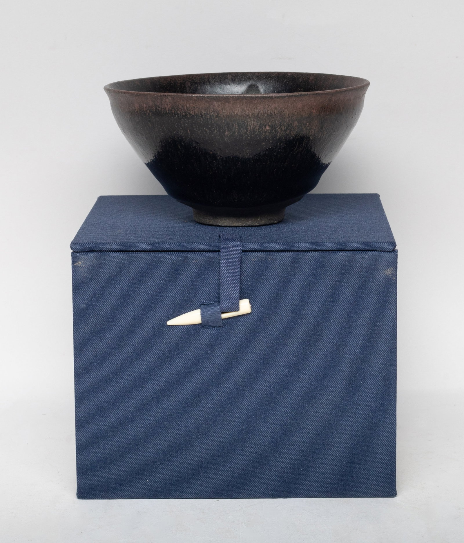 Estate Chinese Jian Type Porcelain Bowl: Of conical form with a short foot, overall covered with streaked black glaze, the interior with white drop shaped splashes, the thick glaze stopping above the foot, with box. Approx. 4.9*2.5 inch (bow