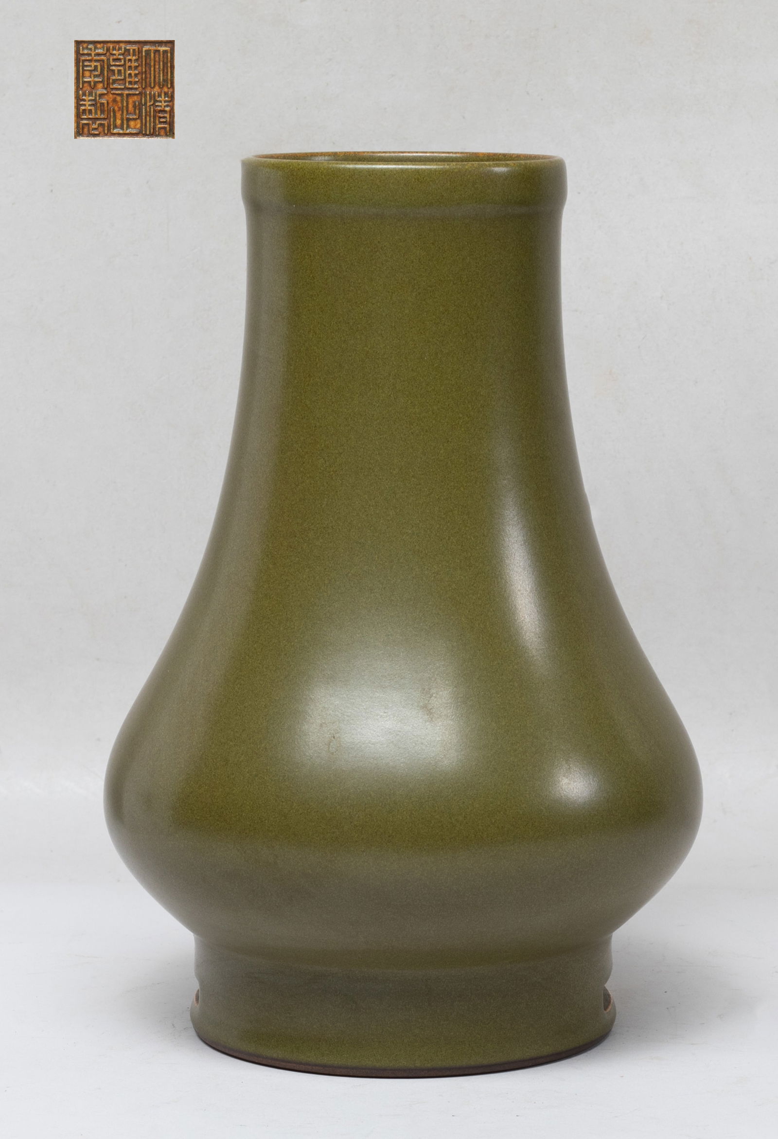 Chinese Tea Dust Glazed Porcelain Vase: Of compressed pear shape rising from a cylindrical foot to a columnar neck, overall covered with tea dust glaze, the bottom incised with a six-character mark. Approx. 9.2*6.2 inch.