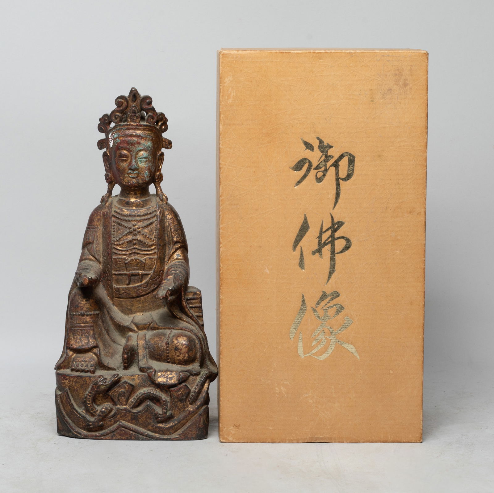 Rare Chinese Bronze Sculpture of Buddha: The Buddha cast in seated pose, the base carved with a stylized dragon, wearing a loose-fitting robe and beaded jewelry, the hands in Shuni mudra, with box. Approx. 9.5*4.6*3.5 inch (w/o box).