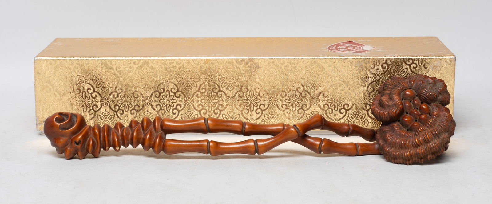 Estate Chinese Boxwood Sculpture of Ruyi: The elongated body made from section of gnarled root, the sceptre of naturalistic form complete with ribbed grooves and gnarled twists with three sprouting twigs with linghzi along the body, terminati