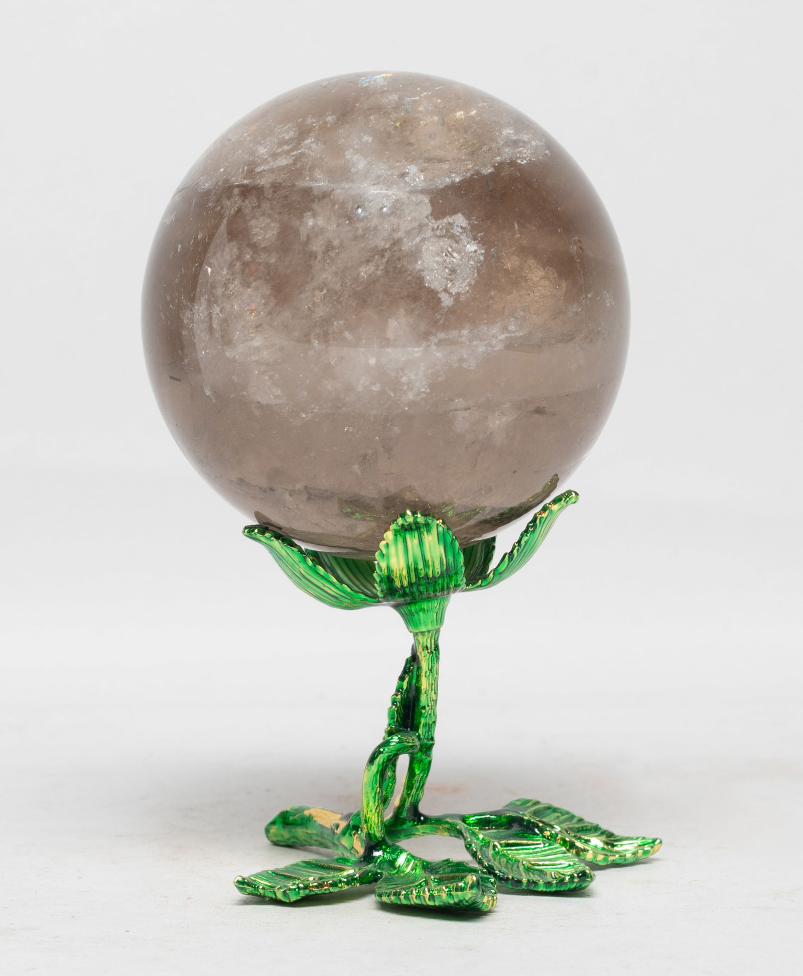 Vintage Rock Crystal Sculpture of Ball: Collectible rock crystal ball sculpture, the surface finely smoothed and polished, with leafy form stand. Approx. 3.2 inch D (ball size). The Estate of the Consignment Store Closed Sale. Laguna Beach.
