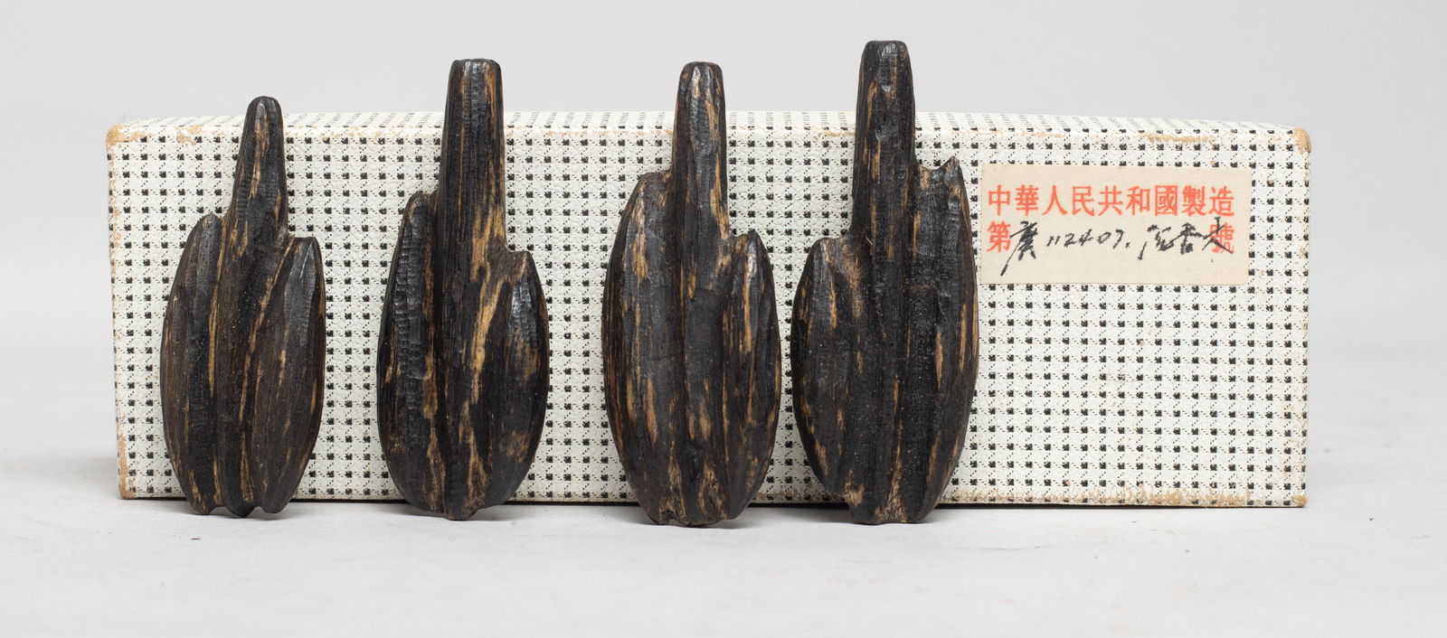 Estate Chinese Export Agarwood Nuggets: Set of four Chinese export agarwood carved nuggets, with box. Approx. 33 gram (total wood weight), 2.68*1.06 inch (largest). The Estate of the Store Closed Sale, K-town, Los Angeles. 2022.