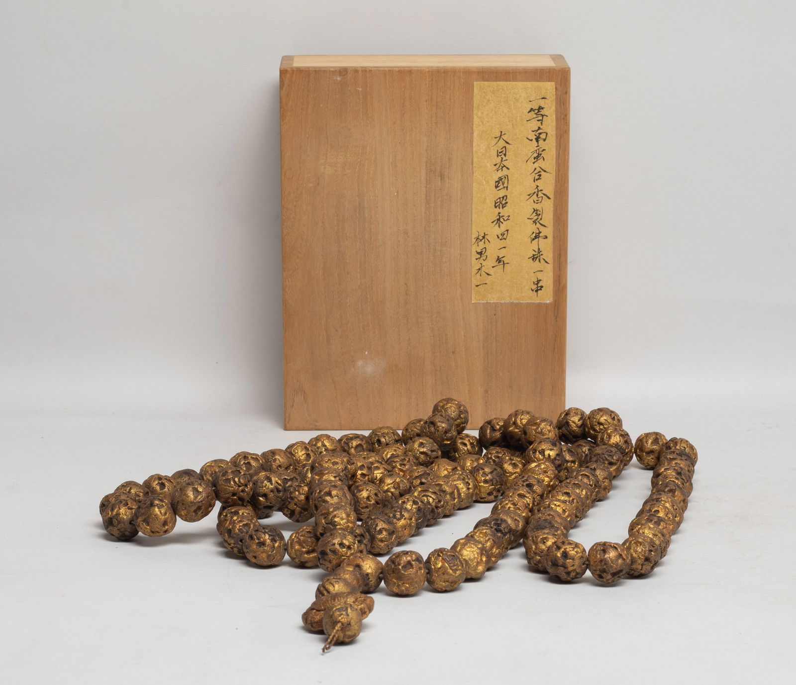 Chinese Mixed Agarwood Hexiang Prayer Beads: A long string of Chinese mixed agarwood Hexiang carved prayer beads, slightly fragrant, with box. Approx. 0.67 inch D 9each bead size).The Estate of the Store Closed Sale, K-town, Los Angeles. 2022.