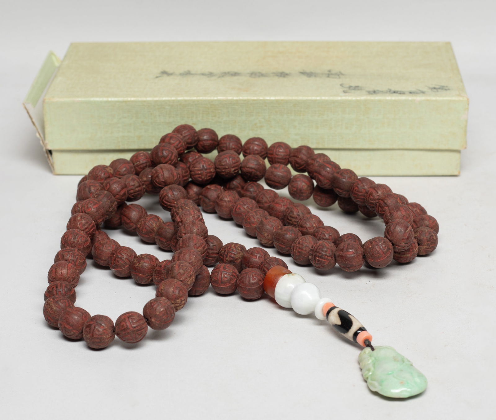 Rare Chinese Mixed Agarwood Hexiang Prayer Beads: Collectible Chinese mixed agarwood Hexiang prayer beads, with a jade bead, an agate bead, a dzi bead, and a jade pendant carved with melon and bat, with a broken box. Approx. 0.5 inch D (each Hexiang