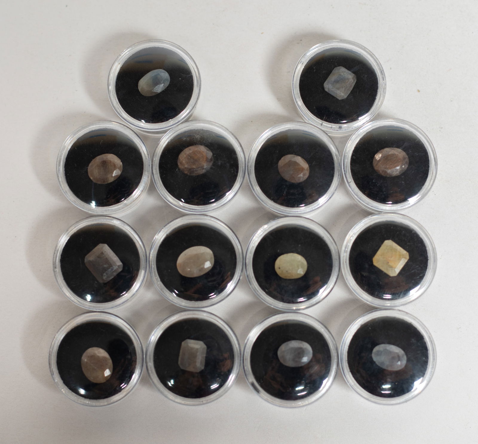 Set Lg Size Gemstone Cut Ring Face: Collection of large size gemstone cut ring face, with cases. Size varies. The Estate of Store Moving Sale, Downtown Los Angeles. 2025.