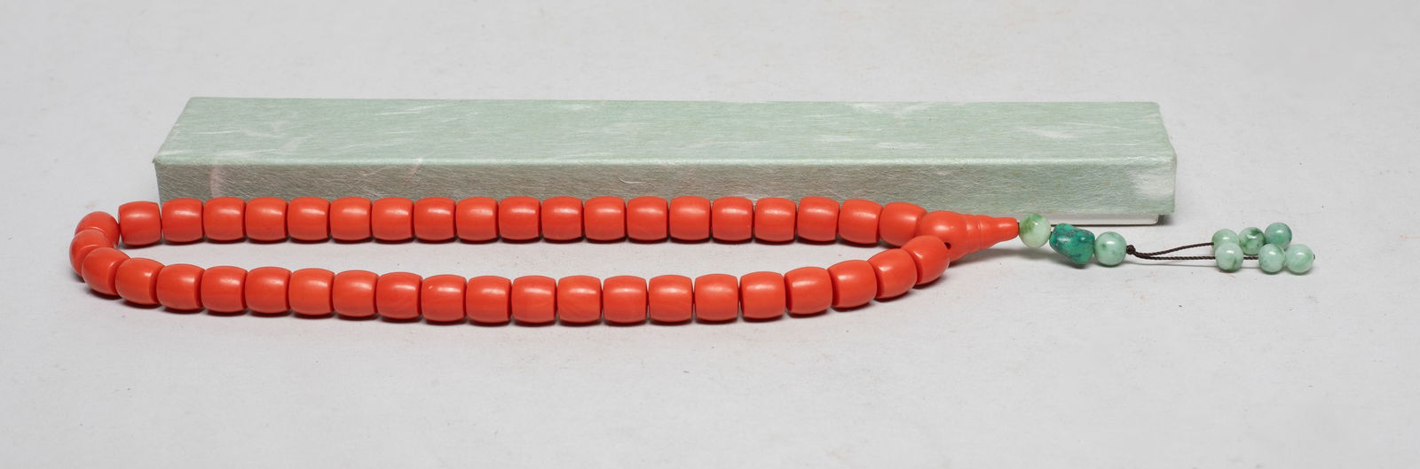 Estate Vintage Chinese Export Prayer Beads: A string of vintage Chinese red color prayer beads, suspended with celadon color beads, with box. Approx. 15 inch L. The Estate of the Store Closed Sale. Little Tokyo. CA. 2023.