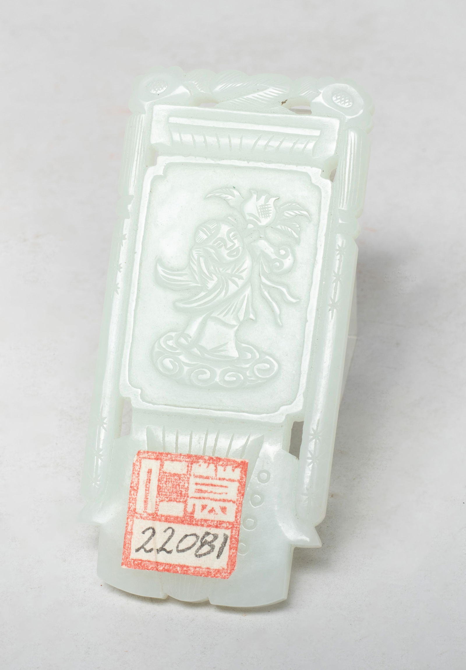 Estate Chinese Jade Carved Pendant: Special shape Chinese jade pendant, one side carved with a figure standing on clouds and holding a leafy stem issuing lingzhi and pomegranate, the reverse inscribed with a four-character mark.