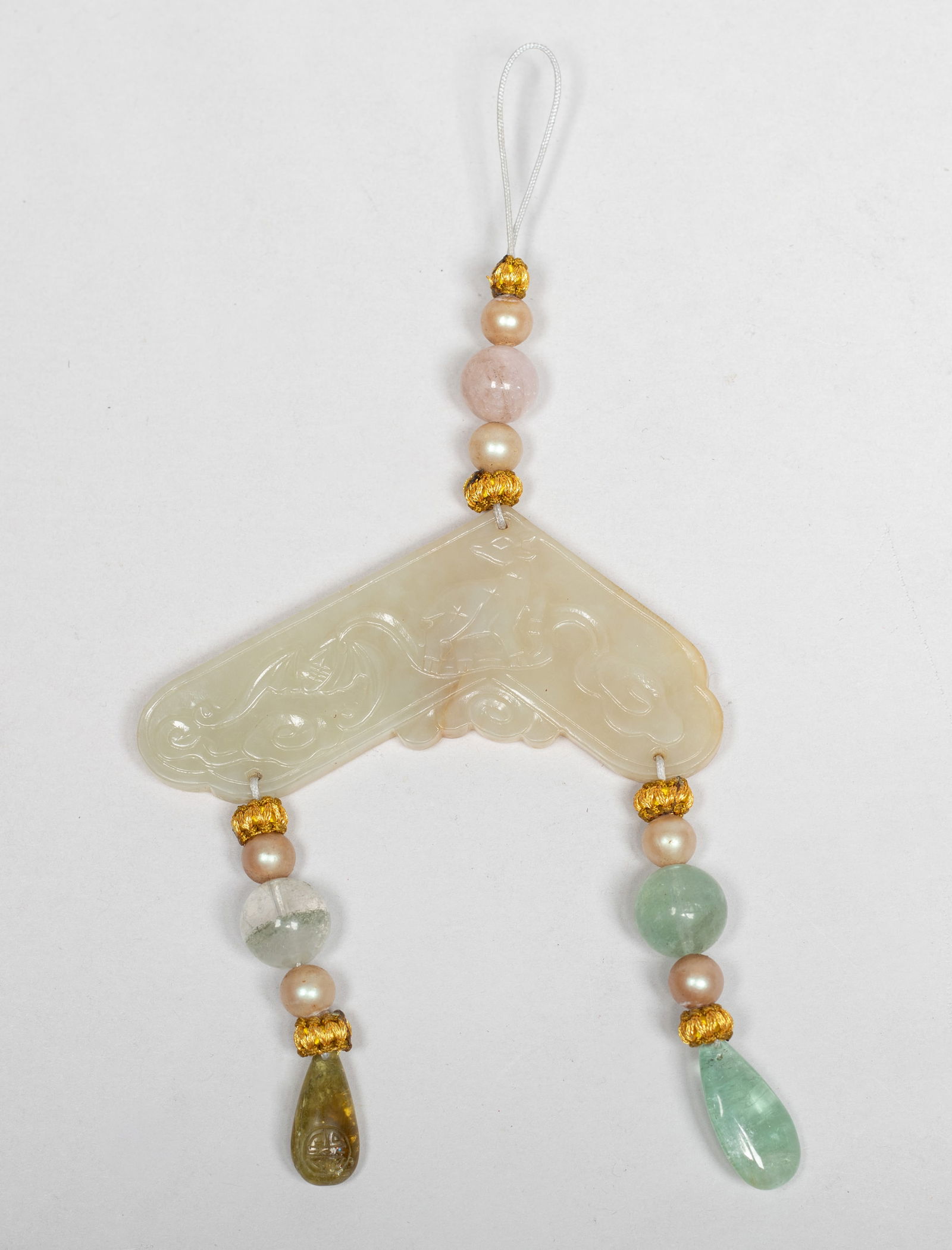 Chinese Manchu Form Jade Pendant: Chinese russet jade pendant of traditional instrument form, one side carved with a deer and a bat among clouds, the reverse inscribed with characters, with pearl-like beads and quartz gemstone beads.
