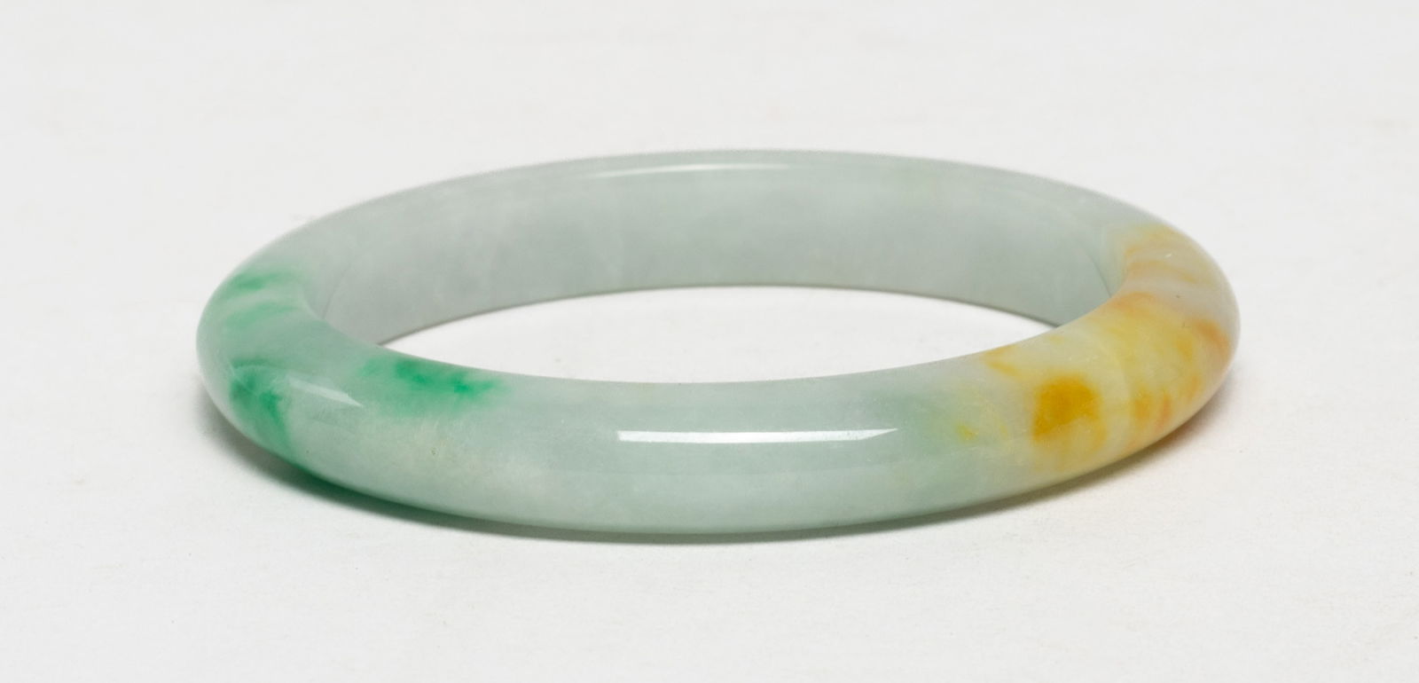 Chinese Export Jade Bangle: Chinese export jade bangle. Approx. 2.93 inch outer diameter, 2.27 inch inner diameter. The Estate of S Pasadena, CA, 2024.