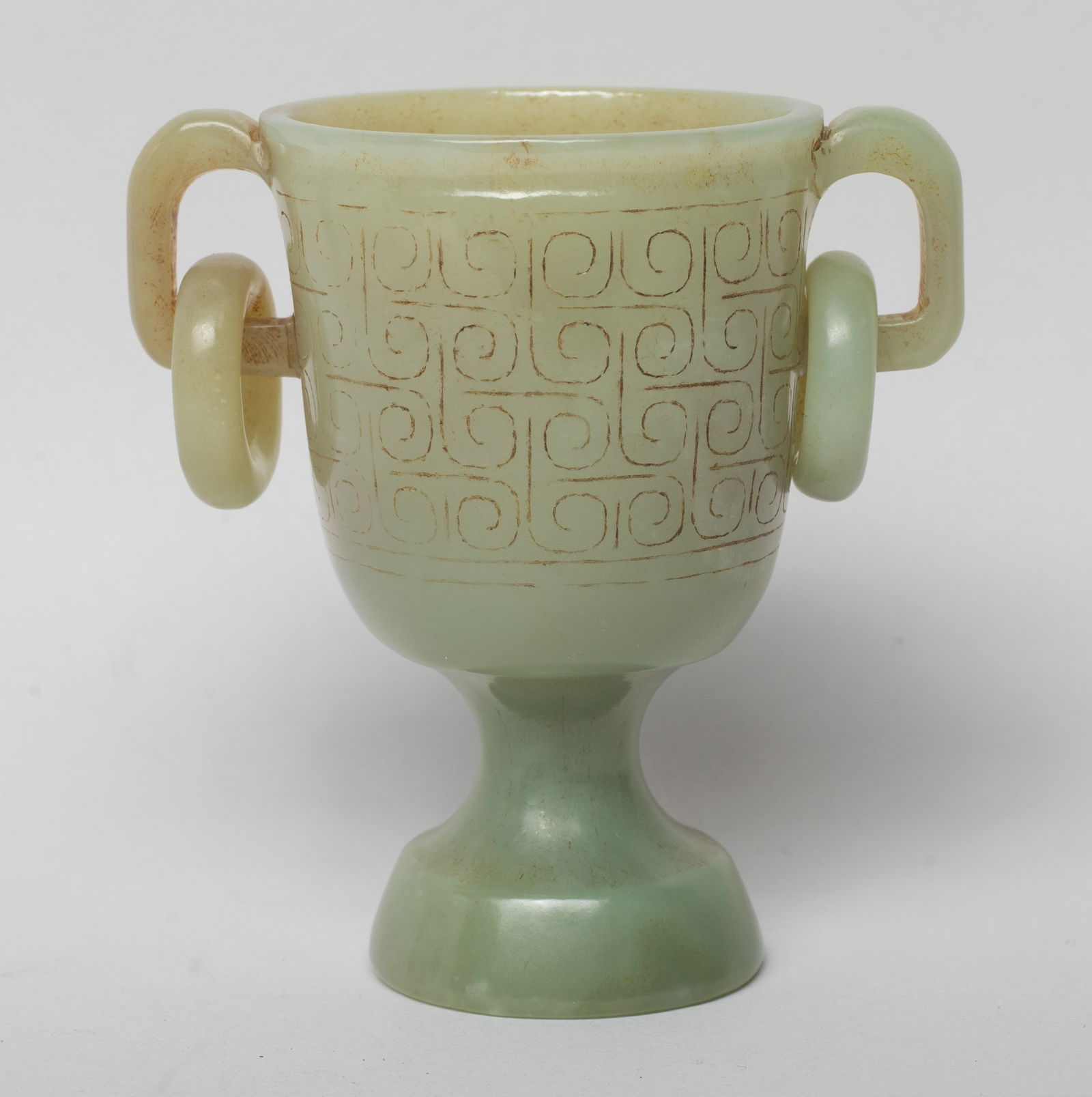 Collectible Chinese Russet Jade Cup: Chinese russet jade cup, carved in low relief with a wide band of continuous scrolls, flanked by a pair of loop handles. Approx. 2.9*2.8*1.85 inch.
